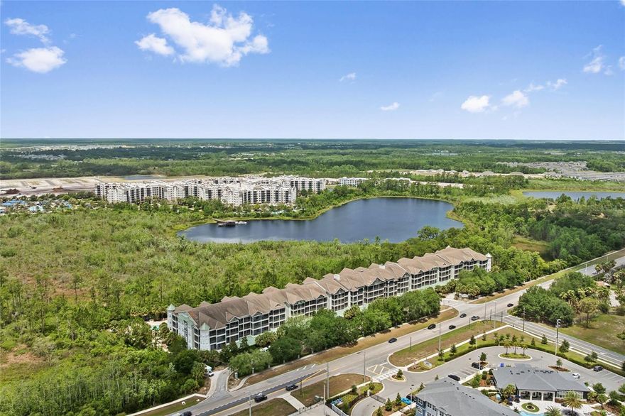 Welcome to The Palisades Condominium, a hidden gem just 15 minutes from Walt Disney World where convenience, comfort, and flexibility come together beautifully. Whether you’re looking for your own Central Florida getaway, a seasonal retreat near the parks, or a property that can generate short-term rental income to help offset monthly expenses, this fully renovated and furnished TOP-FLOOR condo offers an exceptional opportunity.

Located in a smaller, quieter condominium community built in 2008, this spacious 2-bedroom, 2-bath residence offers more than 1,200 square feet of stylish living space designed for both relaxation and practicality. One of the most appealing features for owners and guests alike is the convenience of covered parking and elevator access directly from the recently renovated lobby to the top floor, no exterior staircases, no long walks carrying luggage or groceries, and added privacy with no neighbors above you.

Inside, the condo has been professionally renovated, decorated, and furnished, creating a true turnkey experience. Luxury vinyl plank flooring flows throughout the home, complemented by crown molding, upgraded lighting, modern hardware, and an elegant kitchen featuring 42-inch white cabinetry, stainless steel appliances, and tasteful finishes throughout. A full-size washer and dryer are also included.

The split-bedroom layout provides excellent privacy whether hosting family, friends, or guests. The spacious primary suite features a king bed, 52-inch Samsung LED TV, walk-in closet, and an en suite bathroom with a relaxing garden tub. The second bedroom includes two queen beds, a 55-inch Samsung LED TV, built-in closet, and direct access to a second full bathroom with additional hallway access for guests.

The open living and dining space is ideal after a day at Disney or enjoying Central Florida attractions, whether gathering for dinner, movie night, or simply unwinding. Large sliding glass doors bring in abundant natural light and open to an oversized screened-in balcony accessible from both bedrooms and the living room, offering a peaceful space to enjoy the Florida breeze.

Ownership here is designed to be simple and low-maintenance. The condominium association dues cover nearly all monthly services and utilities, including water, internet, cable, exterior maintenance, amenities, and more, leaving electricity as one of the only primary owner utility expenses. This makes budgeting far more predictable for both personal use and rental purposes.

Residents and guests also enjoy resort-style amenities including:

Covered owner and guest parking;  Elevator access;  Resort-style pool and hot tub;  Fitness center;  First-floor theater room;  Beautifully maintained common areas.

Rarely do you find a fully furnished, professionally updated, top-floor condo in such a convenient Central Florida location that combines personal enjoyment, quiet comfort, and income potential so seamlessly.