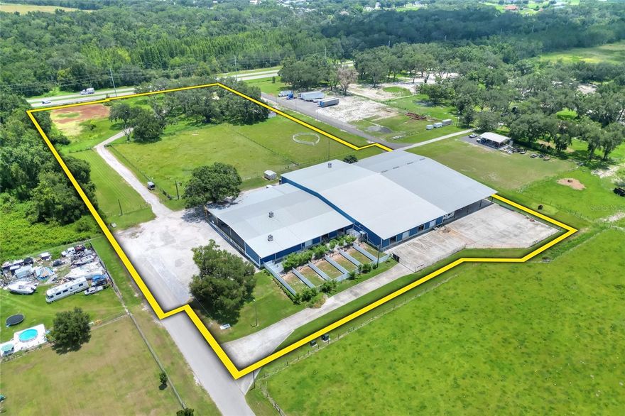 Positioned on County Line Road and E Trapnell Road in Plant City, this 53,032± sf warehouse sits on 8.93± acres in the heart of one of Central Florida’s fastest-growing industrial corridors. The property offers prime frontage with a valuable median break for full access and is located just 4.5 miles from the I-4 interchange, making it an ideal site for current use and future growth. Currently zoned AS-0.4 with a future land use of AE, the site supports a variety of approvable uses and offers strong long-term upside as the corridor continues to expand.
The facility features approximately 53,032sf under roof, including 30,432sf of enclosed space, 432sf office, a 9,000sf covered dock area, and a 13,168sf covered concrete pad – ideal for outdoor work or covered storage. Inside, a 3,600 square foot mezzanine provides additional functional space for storage. With 13 loading docks and 3-phase power, the layout supports a wide range of operational needs and offers a flexible configuration for most users. In addition to its County Line Road access, the property features an entrance off E Trapnell Road, improving circulation and site flexibility. An additional 5+ acres of vacant land is included in the sale, offering room for outdoor use, expansion, or future development. This is a rare opportunity to acquire a versatile facility in a high-growth corridor with immediate utility and long-term investment potential.