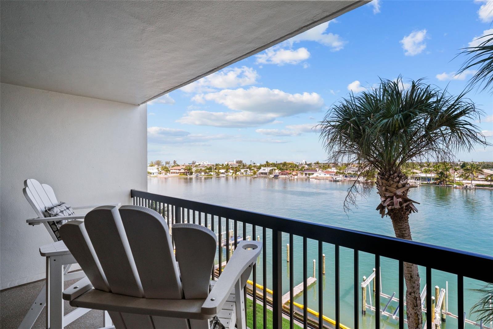 St. Pete Beach Yacht & Tennis Club offers Resort Style living between two charming beach communities. This waterfront condominium residence has an open concept living area, two spacious bedrooms and two full baths. The northern view offers wide open views of the Intracoastal from the private patio – providing glorious sunrises over Boca Ciega Bay and breathtaking sunsets over the Gulf. This residence has been fully updated from the ceilings to the floors and every detail in between. The modern kitchen has granite countertops, new kitchen cabinets and stainless appliances, a large pantry for storage, island for meal preparation and a breakfast bar. The entertainment area has ample space for the dining table which seats 6 guests and a comfortable living room for streaming your favorite shows or hosting game night. The primary suite has a king bed, walk-in closet, ensuite bath and sliding doors to the private patio. The guest bedroom has a queen bed, large built-in closet and access to the second full bath. Private laundry in the unit has new full-sized washer and dryer. Enjoy tennis clinics, clubhouse, fitness center, shuffleboard, pickleball, community pool & spa. A short walk to restaurants and Treasure Island Beaches, and a short drive to downtown St. Petersburg! While all ages are welcome, no pets are allowed and no smoking permitted. Owner prefers a long term tenant. Rental Rate is determined by the length of stay. Boat slip with lift may be available for an additional monthly fee.