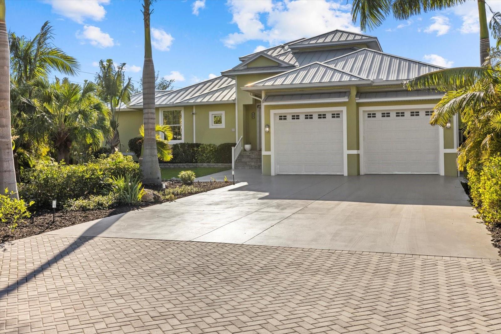 Discover the epitome of waterfront living in this stunning Key West-style retreat on the tranquil shores of Phillippi Creek. Nestled among lush tropical landscaping, this 4-bedroom, 3-bathroom estate offers an unparalleled blend of elegance, comfort, and coastal charm. Step inside to an open-concept design filled with natural light and sweeping water views. The gourmet kitchen is a chef’s dream, featuring stone countertops, premium appliances, and custom cabinetry—perfect for entertaining in style. Enjoy music throughout the home with a built in speaker system. The spacious primary suite is a private oasis, boasting French doors that open directly to the screened lanai, offering serene water views and effortless indoor-outdoor living. The en-suite bathroom is designed for relaxation, complete with a soaking tub, walk-in shower, and dual vanities. A large walk-in closet provides ample storage and organization. Enjoy breathtaking water views from the private screened lanai, where a resort-style pool and outdoor dining area create the perfect setting for sunset cocktails. Boating enthusiasts will love the private dock with a boat lift, providing effortless access to Sarasota Bay and the Gulf beyond. Upstairs, a luxurious guest suite awaits, complete with a private balcony overlooking the shimmering waters—ideal for visitors or a personal retreat. Impact windows and doors along with an elevation certificate provide additional peace of mind. A rare opportunity to own a slice of paradise, this waterfront sanctuary embodies Florida luxury living at its finest.
