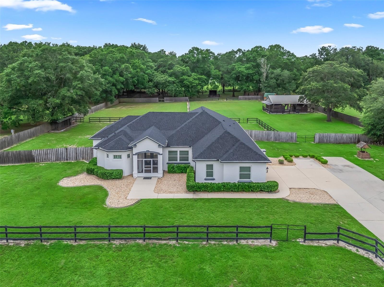 Beautiful, pristine 3 acre mini farm just one block from the World Equestrian Center. This immaculate and beautifully updated custom 3 bedroom, 2 and 1/2 bathroom home is complete with a spacious gourmet kitchen, formal dining room, breakfast nook overlooking riding area, 2 large living areas and split bedroom floorplan. The master suite is large & inviting with a sitting area, 2 large walk in closets. This farm is complete with 3 paddocks w/ nice mature oak trees, a nice riding area, 3 stall center aisle barn complete with screened sitting area, feed/washroom, separate feed/hay building, and so much more! The property is offered fully furnished and turnkey. Don’t miss this special property!