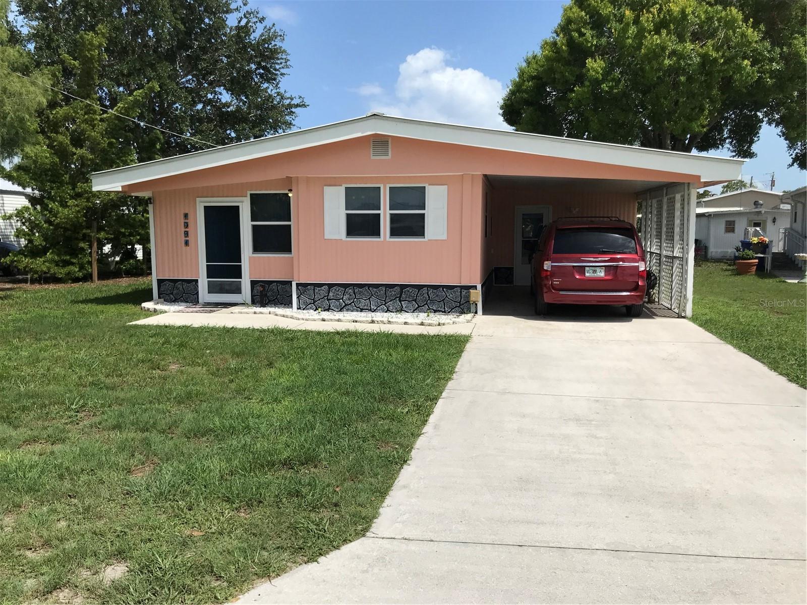 **Waterfront Getaway with Boathouse and Canal Views**
Looking for a peaceful place to kick back and enjoy the water? This 2-bedroom, 1-bath home sits right on a freshwater canal and comes with its own boathouse, boat lift, and a fish cleaning station—perfect for anyone who loves spending time on the water.
The backyard is fully fenced, so it’s great for pets or just hanging out with some added privacy. There’s also a screened-in lanai where you can relax and take in the view without worrying about bugs or weather.
Whether you’re into boating, fishing, or just want a quiet place to call home, this one’s got you covered. It’s simple, comfortable, and all about that laid-back, waterfront lifestyle. (All measurements are approximate.)