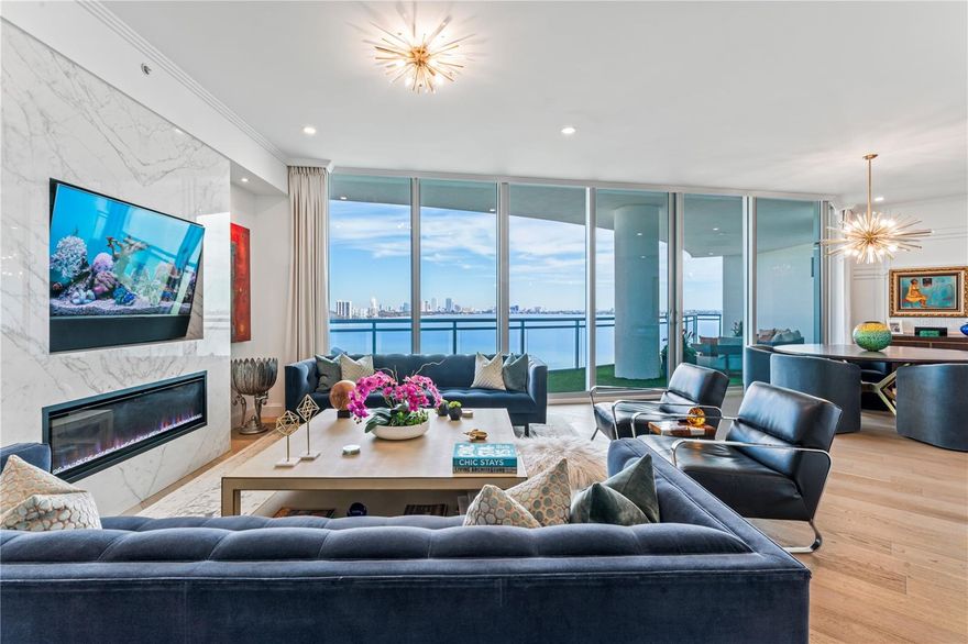 MUST SEE this dreamy stunningly designed condo inspired by the Baccarat Hotel in NYC. The views are absolutely breathtaking with expansive water views framing a picture-perfect postcard view of Downtown Tampa, by far the best view on Bayshore. If you love the daytime views, the nighttime views are even better!  Every detail of this home has been painstakingly designed and customized to create a true luxury oasis in the sky.  Step off the elevator directly into your private foyer with beautiful black and white geometric tile and notice the uniquely designed millwork with "scorched" wood walls, and a gold leaf ceiling. The home features hardwood flooring throughout, gorgeous custom cabinetry, double thick quartz kitchen island, Wolf Induction Cooktop (wired for gas if you want a gas range), Subzero Refrigerator and all finished off with a beautiful custom marble backsplash. Upgrades are nearly endless in this home and include: built-in electric fireplace with book matched porcelain "marble" slabs, Sonos system with Ghost speakers in the foyer, living, and dining rooms, turf covered oversized balcony, custom electronic voice controlled drapes and lighting, venetian plaster bathroom, wall treatments +++ The Virage is a luxury high-rise featuring 24/7 concierge, pool overlooking Bayshore, spa, grilling area, fire-pit, club room, meeting room, a large gym, massage room, private dog walk, dog spa, bike room, air conditioned storage, and 2 guest suites which can be reserved for your guests. Come live the lifestyle you deserve at the Virage Bayshore!