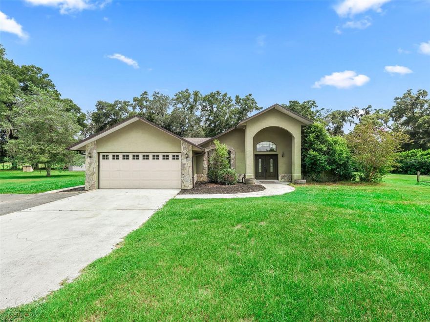EXCELLENT LOCATION!  This beautifully maintained concrete block home is situated on a quiet street in close proximity to Ocala and The Villages.  This home boasts a highly desirable split bedroom floor plan and the primary suite has an attached flex space (perfect for a sitting area, office, workout area, or nursery).  The primary bathroom is well appointed with a large tub, walk in shower and dual vanities.  The open kitchen has granite counter tops, a lot of storage, and a breakfast nook, plus a formal dining is situated near the kitchen.  BONUS:  plenty of space to roam!  This home sits on 3.5 acres to ensure you have just enough room to spread out and enjoy doing the things you love the most.  BRING YOUR TOYS!! In addition to this lovely 3 bedroom, 2 bath, 2 car attached garage, POOL home; you'll find the extra storage you need in the detached 2 bay workshop with attached carport/equipment storage area.  The workshop is FULLY INSULATED and has AC.  There is an additional garden shed that is large enough that it could be turned into a great she-shed or simply keep it as is to store all of your gardening equipment.  There is a large concrete RV pad located behind the workshop.  Relax by the salt water pool at the end of the day, or jump into the spa and soak for a bit under the screened enclosure.  All of this plus the ENERGY EFFICIENCY of SOLAR panels.  There are so many reasons to put this house on your "must see" list.  Make an appointment today!