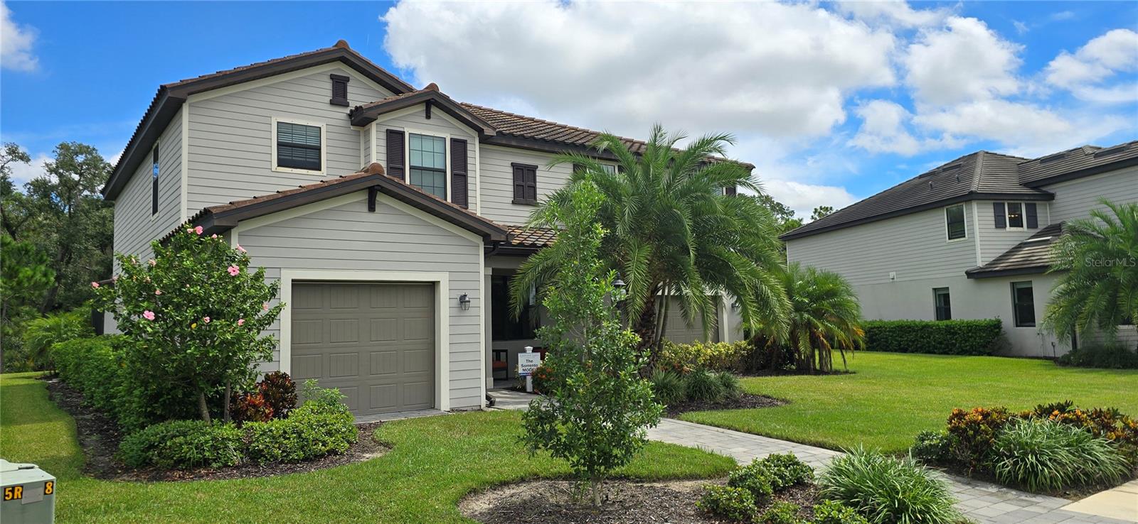 This is your chance to own a professionally furnished Model Home!
Experience the splendor of a professionally designed model home with this exceptional Sorrento floor plan. This impressive two-story home features a spacious layout perfect for entertaining and family living. The first floor boasts an open-concept design, including a living room, formal dining room, a modern kitchen with granite countertops and stainless steel appliances, a guest suite, and a covered lanai. Upstairs, you will find the luxurious owner's suite, three additional bedrooms, and a versatile loft space.
This home is equipped with Low E Double Paned windows and features a tile roof. Situated in the sought-after Lorraine Lakes community at Lakewood Ranch, residents enjoy access to a gated entrance, a resort-style swimming pool, a state-of-the-art fitness center, tennis and pickleball courts, and a grand clubhouse. This is an incredible opportunity to own a professionally decorated model home in a community with outstanding amenities. A Driveway will be installed prior to occupancy * Furniture sold separately * Some photos are for display only - Please Verify home and decor.
