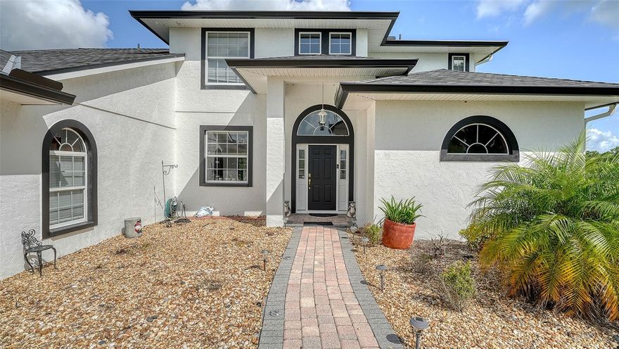 Welcome to Saddle Oak Estates, one of Sarasota’s most prestigious gated Equestrian communities, where privacy, space and serenity come together.  Tucked away on 7.56 acres, at the end of a peaceful cul-de-sac, this exceptional 5 bedroom, 3.5 bath estate offers the perfect blend of luxury and country charm.  Inside, you find two expansive primary suites – one upstairs, one downstairs – each with spa like baths featuring jacuzzi tubs, providing ultimate flexibility and privacy for multigenerational living or guest accommodations.  A personal movie theatre with stadium seating sets the stage for unforgettable nights of entertainment, while the soaring ceilings in the living room and elegant crown molding in the formal dining room add timeless sophistication.  The kitchen offers clean lines, generous counter space, and tranquil views of the outdoors. Enjoy year-round Florida living in the glass-enclosed lanai with dual triple sliders and paver flooring – an inviting transition to the spectacular outdoor living area. Step outside to your own private resort. An expansive 15,000 square foot paver patio wraps around a stunning heated pool, custom boulder-accented spa and water feature.  Beyond is a tranquil pond stocked with fish and enhanced by a bubbling fountain. Need shade? Simply extend the retractable sunshade awning for comfort.  Additional features include a Brand NEW 2024 roof, triple zone A/C system, water treatment system, 4 car garage and fencing on 3 sides. Whether you are looking for a quiet retreat or a dynamic lifestyle property, this estate offers unparalleled space, comfort and location.  This is where luxury meets laid back country living!