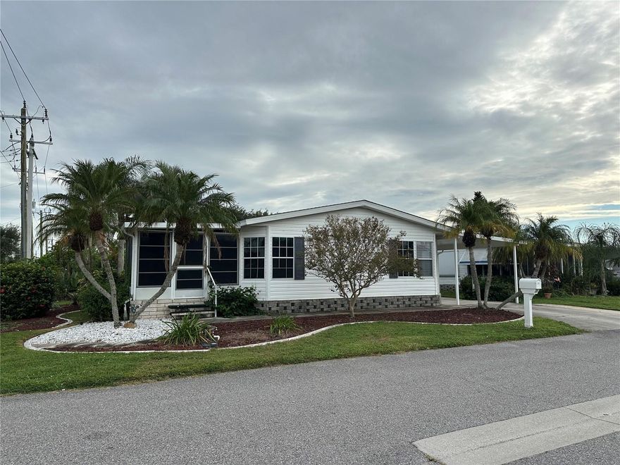 Welcome to Paradise in Harbor Isles! This beautifully maintained double-wide manufactured home is perfectly situated on a desirable corner lot in the award-winning 55+ community of Harbor Isles. Surrounded by lush, mature landscaping, this home offers both privacy and charm. Enjoy year-round comfort in the inviting Florida room, complete with a mini split system for cooling and relaxation. The open-concept kitchen, dining, and living areas feature easy-care laminate flooring—ideal for entertaining or everyday living. The spacious primary bedroom includes a full ensuite bath with walk-in shower, plus there’s a comfortable guest room and hall bath for visitors. An oversized storage shed, interior washer and dryer, and abundant natural light make this home as functional as it is welcoming. Start living the resort lifestyle today in Harbor Isles—where every day feels like a vacation!
