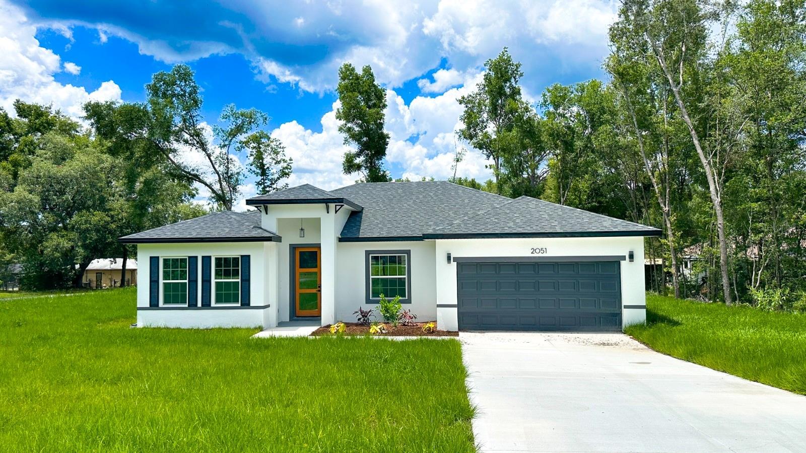 Brand-New Home, Move-in Ready in Citrus Springs – Modern Design, Spacious Living & Peaceful Surroundings. Offering 1,774 sqft of climate-controlled living space and a total construction area of 2,213 sqft.
Discover this beautifully built 4-bedroom, 2-bathroom single-family home located in the thriving and tranquil community of Citrus Springs, FL. Thoughtfully designed with both comfort and functionality in mind, this gorgeous residence offers everything you need for modern Florida living.
Step inside to an open-concept floor plan filled with natural light and clean architectural lines. The heart of the home is the stylish kitchen, featuring quartz countertops, a center island with a built-in sink and a waterfall side, light-toned cabinets, stainless steel appliances, and a generous workspace, ideal for home cooking or entertaining guests. The kitchen flows seamlessly into a spacious living and dining area, creating a welcoming space for daily living and family gatherings.
The split-bedroom layout ensures privacy, with the primary suite offering a large walk-in closet and a beautifully appointed ensuite bathroom. All bedrooms are generously sized and include ample closet space. Durable and attractive vinyl wood plank flooring runs throughout the home, making upkeep simple and providing a clean, contemporary look.
Additional highlights include a dedicated laundry room, a 2-car garage with a painted floor, a covered front entry, floor-to-ceiling tiled showers, matte black fixtures, and lighting. The property sits on an oversized lot, offering a spacious backyard with plenty of potential for outdoor living, gardening, or future additions.
Located just minutes from shopping — including Publix, Walmart, Target, ALDI, Starbucks, parks, schools, springs, boating, horse riding, a golf course, and the Withlacoochee State Trail. Citrus Springs is known for its quiet charm, natural beauty, and easy access to Florida's Nature Coast.
Whether you're a first-time buyer, a growing family, or looking for a wise investment, this home checks all the boxes. Don't miss your opportunity—schedule your private tour today!