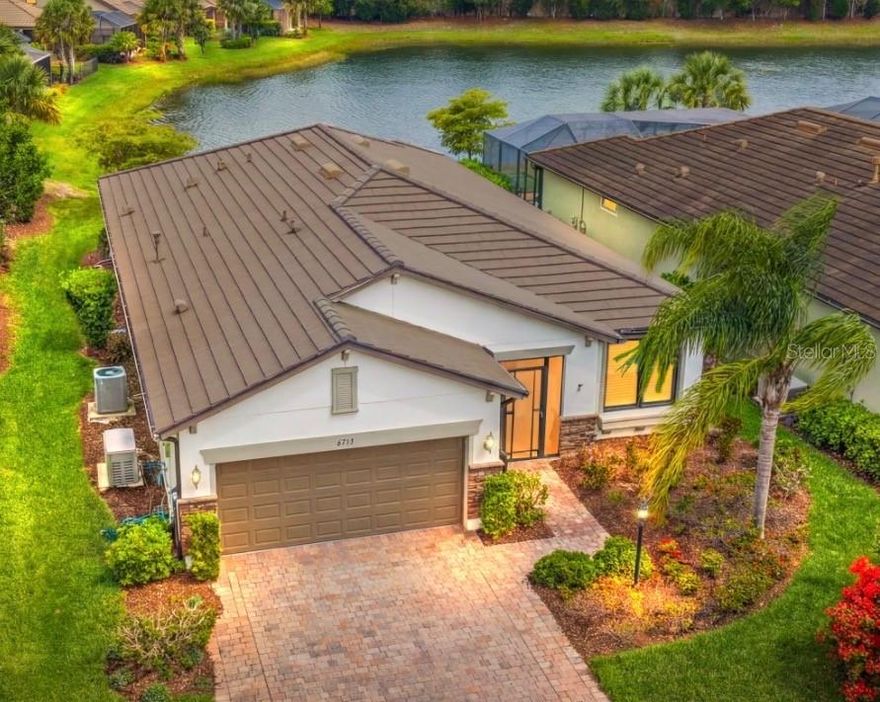 LIVE ON VACATION NOW! Start living your BEST LIFE in this GORGEOUS MAINTENANCE-FREE home in the RESORT STYLE 55+ COMMUNITY OF DEL WEBB!  Every day truly feels like vacation! NO STRESS and so many activities to choose from!

This MARTIN RAY model the OPEN FLOOR PLAN and features 2 bedrooms, 2 bathrooms, PLUS a flexible den/office/3rd bedroom! Interior highlights include PORCELAIN TILE set on the diagonal, CROWN MOLDING, CUSTOM ACCENT WALLS, NEW PAINT THROUGHOUT, and UPGRADED LIGHTING! LIGHT AND BRIGHT!

The GOURMET KITCHEN is tailored for both everyday living and entertaining, complete with STAINLESS STEEL APPLIANCES, a gas range, GRANITE COUNTERTOPS, HUGE OVERSIZED ISLAND, WALK-IN PANTRY WITH WINE REFRIGERATOR AND COFFEE BAR! 

You will LOVE your SCREENED LANAI with PEACEFUL POND VIEWS, the perfect place for morning coffee or Happy Hour!  Additional features include NEW FLOORING in all bedrooms (no carpet), a functional MUDROOM ALCOVE, and a 2-car garage with dedicated 3 space for GOLF CART PARKING.

NEVER WORRY ABOUT STORMS BECAUSE THIS HOME IS READY! Constructed with an emphasis on durability and preparedness, the home includes a WHOLE HOUSE GENERATOR, SURGE PROTECTION, IMPACT WINDOWS, and MOTORIZED KEVLAR SCREEN on lanai, allowing for efficient storm readiness.

DEL WEBB at Lakewood Ranch is a gated 55+ community designed for those who want more than just a home; they want a lifestyle! Here, every day feels like a vacation with resort-style amenities, social activities, and plenty of opportunities to stay active or simply relax. * Resort Style Heated pool! * Tennis Courts and Pickleball * Bocce Ball * Fitness Room * Wonderful Restaurant and Bar! Great place to hang out and socialize!! The homes are thoughtfully crafted with low-maintenance living in mind, offering modern features, flexible layouts, and energy efficiency that make life easier. Surrounded by lush landscaping, sparkling lakes, and scenic walking trails, it’s a community that feels peaceful yet perfectly connected. Plus, you’re just minutes from shopping, dining, and the vibrant arts scene in Sarasota and Bradenton. The World-famous beaches are only 20 miles away! This life is not a dress rehearsal, LIVE ON VACATION NOW!