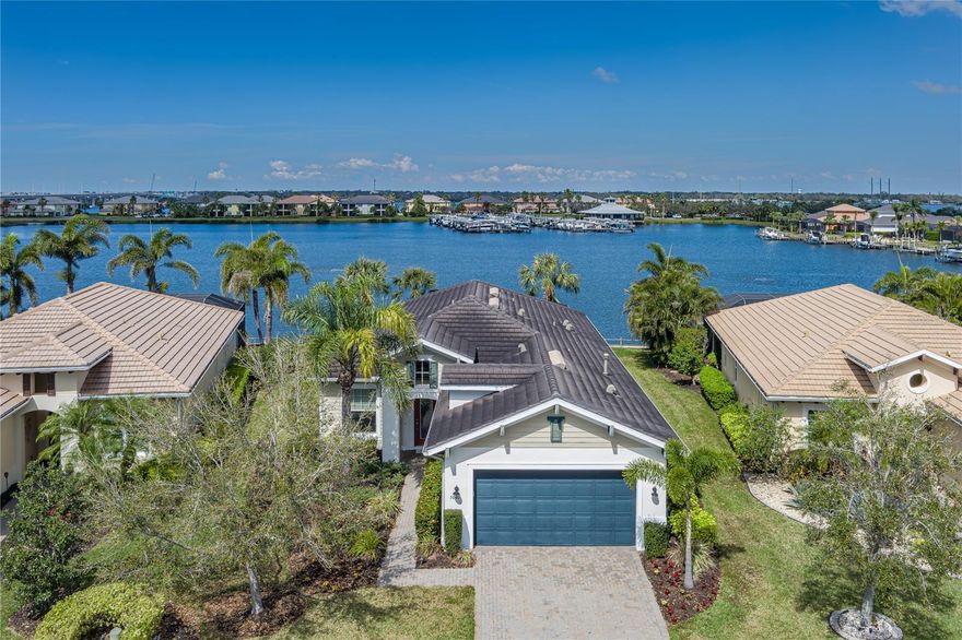 ANOTHER SIGNIFICANT PRICE IMPROVEMENT - JUST REDUCED $10,000!! COME CLAIM YOUR SLICE OF PARADISE!! This waterfront home in the gated community of Tidewater Preserve has everything you need to enjoy the Florida lifestyle. Features include an amazing water view, boat dock with 9,000 lb lift, NEW SEAWALL, large open floor plan, luxurious primary bedroom suite, 2 guest bedrooms plus den and/or dining room with French -doors, high tray ceilings with crown molding, water treatment system in kitchen, spacious screened outdoor lanai, and heated saltwater pool/spa. This premier boating community provides Gulf access via the Manatee River, maintenance free grounds, 24/7 guard gated access, Har-Tru tennis courts, fitness center, 2 clubhouses, dog park, kayak launch and storage, HD cable and internet with NO CDD and modest HOA fee. The location provides easy commuting to Bradenton, Sarasota, St Pete, Tampa, and world class shopping restaurants, and beaches. With a lifestyle director and many clubs and activities, you will fall in love with your new lifestyle!!