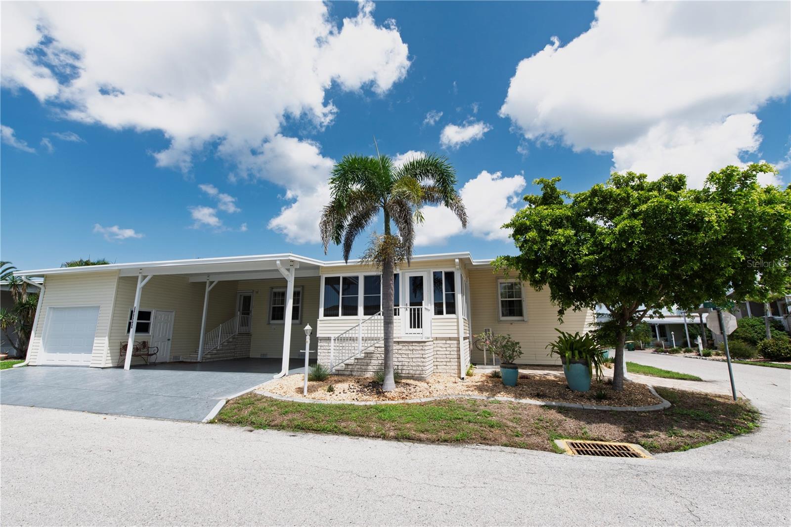 Nestled in the secure, resident-owned, 55+ gated community of Windmill Village, this partially furnished 2012 Jacobson home spans 2,332 square feet on a desirable corner lot. Featuring an open-concept design with drywall throughout, the home boasts three bedrooms, two bonus rooms, two bathrooms, a spacious living room, dining area, a separate laundry room with washer/dryer, and a family room off the kitchen. The large primary bedroom includes a walk-in closet, while a "retreat" bonus room serves as an ideal office or exercise space. There is also another full walk-in/storage closet located across from the laundry room.The modern kitchen offers abundant workspace, a center island, breakfast bar, solid wood cabinets, and new top-of-the-line GE Cafe appliances (January 2025). Recent upgrades include a new roof (2023), Kinetico water system (2022), mini-split system (December 2024), whole-house HVAC (June 2024), and a newly installed lush garden. Enjoy a large all-season sunroom with impact-resistant windows, the home features double-paned windows, storm shutters, a 19x11 storage shed with a garage door, and ample parking with two covered spots and parking in the garage. The $261.00 monthly HOA covers water, trash, sewer, lawn maintenance, and common building upkeep, making this home a perfect blend of comfort and convenience. This active lifestyle community features two private marinas, boat ramp, trailer storage yard, horseshoe pits, shuffleboard, boccé ball, billiards, indoor pickleball, a large community center and many clubs catering to your hobby interests. The Pavilion by the heated pool offers an area for holding gatherings. Punta Gorda was voted “#1 Best Small Place to Live” by Money Magazine and Forbes. Purchase price does not include $18,285.00 for Buy-In Share and Bond, which is refunded when you sell. Don't miss the opportunity to make this thoughtfully upgraded and beautifully maintained home in Windmill Village yours! Schedule your showing today-this is your paradise.