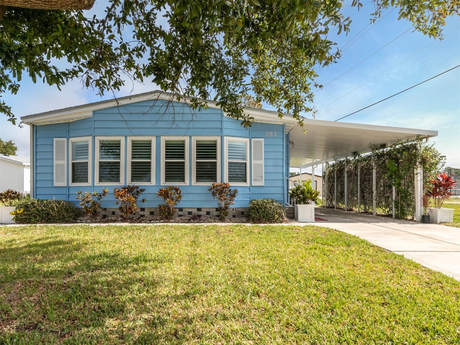 Welcome to the exceptional 1989 manufactured home located in the desirable Harbor Isles community. This beautifully furnished 2-bedroom, 2-bathroom home spans 1,486 square feet and is situated in this resort-like, land-owned, 55+ pet-friendly community! As you step inside, you'll immediately notice the updated kitchen, complete with granite counters and stainless steel appliances. The convenience of an inside laundry closet adds to the ease of living in this home. With an abundance of storage space, you'll have plenty of room to keep your belongings organized. The home features vaulted ceilings throughout, creating an open and spacious atmosphere. The bathrooms have been tastefully updated, boasting vessel sinks and tile showers that add a touch of luxury. Plantation shutters adorn both the living room and primary bedroom, adding elegance and privacy. In addition to the living room, there's a den that provides extra space for relaxation or entertaining guests. Step out onto the screened lanai, accessible from the kitchen and den area, where you can enjoy the Florida weather in comfort. The new carport comes with extended concrete, allowing for an outside seating area where you can unwind and soak up the sun. The location of this home is truly excellent, with amenities within walking distance. The community offers a range of activities year round and 5-star amenities, including a marina, boat launch, and fishing station with access to Charlotte Harbor via the Myakka River. Convenience is key, as the home is located near downtown Wellen Park, the Braves ball field, beaches, dining, shopping, and major interstate access. Additionally, airports are within easy reach, making travel a breeze. Recent upgrades to the home include a new "Corning" shingle roof with two new skylights that are heat reflective. All windows have been replaced, ensuring energy efficiency and a modern aesthetic. The hot water heater was replaced in 2016, and the air conditioning unit is 10 years old. To top it all off, a brand-new 8 x 7 shed has been paid for and will be installed in just five weeks, providing additional storage space for your convenience. Don't miss out on the opportunity to own this exceptional manufactured home in the highly sought-after Harbor Isles community. It's the perfect place to enjoy an active and vibrant lifestyle while relishing the beauty of the surrounding area. Call today for your private tour!