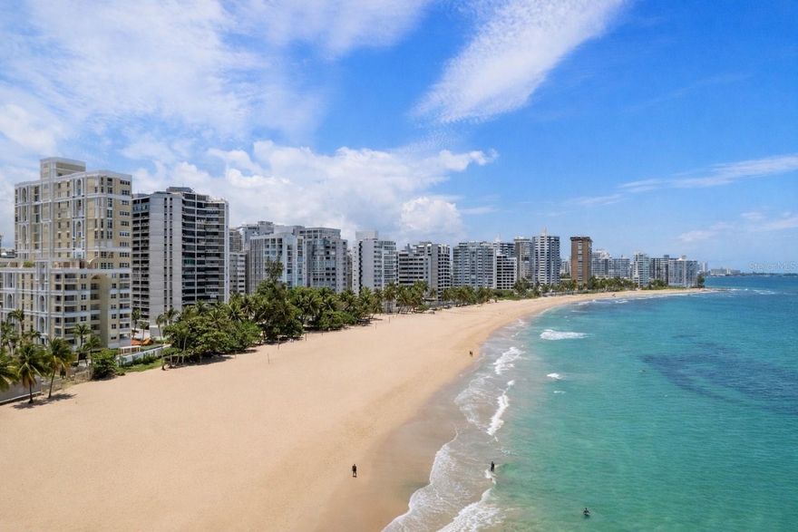 Set directly on the sand at Carrión Court, this residence offers front-row ocean views and a perspective that defines true beachfront living.
This northeast-facing apartment captures endless Atlantic blues from every angle. Wake up to the sound of waves and panoramic views that stretch from the vibrant city skyline to the lush horizon of El Yunque National Forest in the distance. From your private vantage point, you also overlook Ocean Park, where the coastline comes alive daily with energy and sport.
Here, the lifestyle is as compelling as the views. Step directly onto one of San Juan’s most dynamic beaches — home to beach tennis, volleyball, kite surfing, paddle boarding, and kayaking. This is oceanfront living with movement, vitality, and prestige.
The apartment offers 3 bedrooms, 2.5 bathrooms, and two parking spaces. The primary suite faces the water, allowing you to fall asleep and wake up to uninterrupted ocean views — a feature few properties can claim. Offered in excellent, move-in-ready condition, with furniture optionally included for a seamless transition.
Located on a gated street with 24-hour security, the building provides exceptional infrastructure and amenities: double full-capacity generators, cistern, heated pool, expansive terrace, secondary lobby for private gatherings,  a dedicated conference room — ideal for hosting or working in privacy and a gym with new equipment.
Beachfront inventory in this location is extremely limited. Front-line ocean exposure, northeast orientation, protected views, and this level of building quality rarely come together.
If you’ve been waiting for the right oceanfront opportunity — this is it!