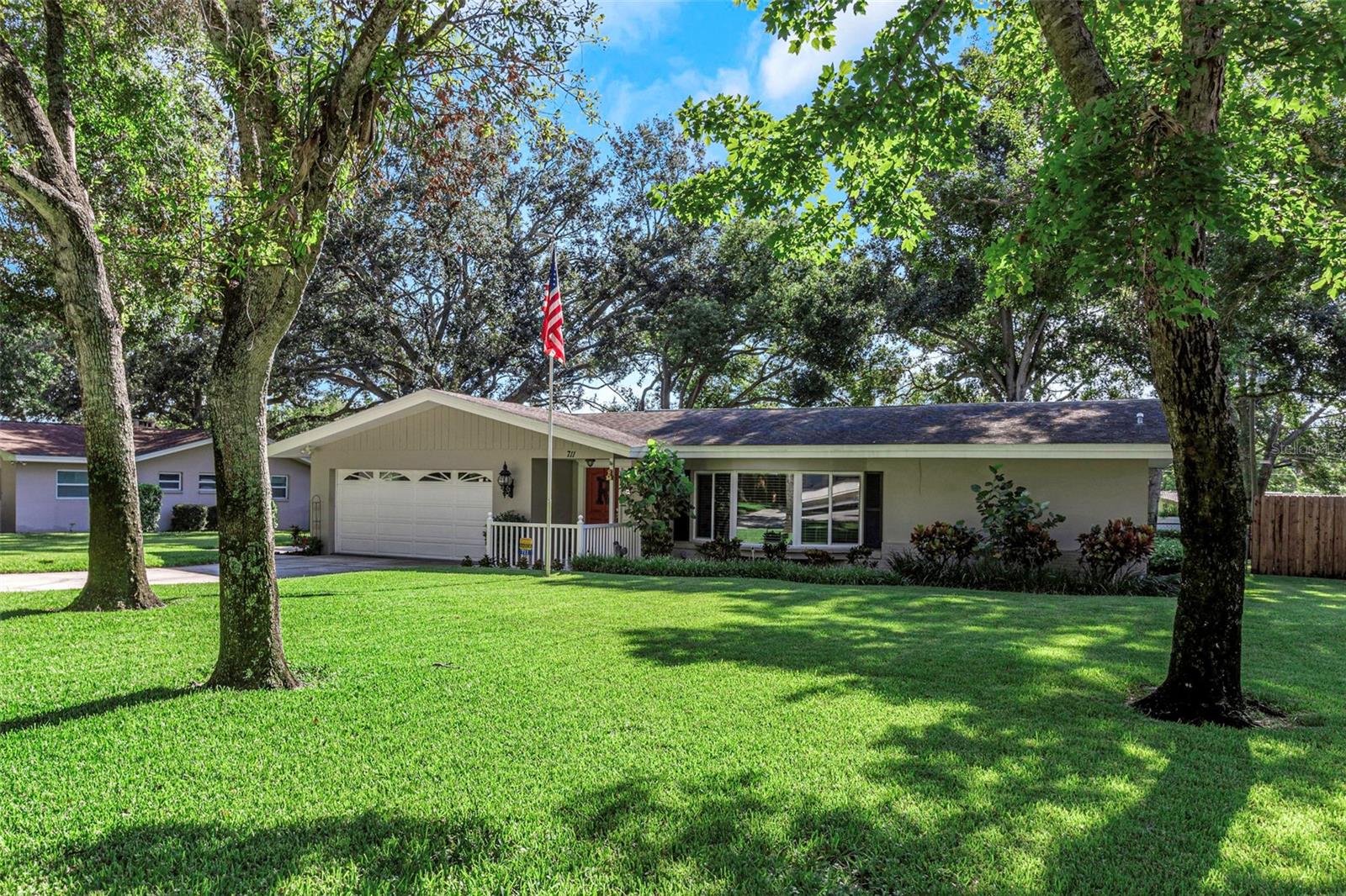 It’s rare to find a 1/3-acre lot in the heart of Clearwater, and this beautifully updated 3-bedroom, 2-bath home delivers just that—set on a quiet dead-end street that offers privacy, peace, and the kind of setting buyers dream of. Surrounded by mature trees and a fully fenced yard, the property feels tucked away while still keeping you minutes from shopping, dining, schools, and the beach.
Inside, the home features genuine hardwood floors throughout—rare to find, in excellent condition, and with no carpet or pets since installation. A spacious family room with a wood-burning fireplace sets the stage for gatherings, while the kitchen offers granite counters, a butcher block island, and newer appliances. One of the home’s most unique details is its hurricane-rated bay window with custom seating built from original wood salvaged from the historic Belleview Biltmore Hotel. Once known as the “Queen of the Gulf,” the Biltmore was a landmark of Clearwater’s past, and having a piece of it here adds a sense of heritage and story you won’t find in another home. Both bathrooms and upgraded trim throughout have been tastefully refreshed.
The home has been carefully maintained with major updates already complete: a 30-year architectural shingle roof (2008) installed with full peel-and-stick adhesive underlayment and improved sloping for superior durability and storm protection, a 4-ton AC with new ducts and returns (2013), Wi-Fi enabled water heater (approx. 4 years old), double-pane windows, and septic pumped February 2025. A deep well provides fresh water and supports the irrigation system.
The backyard is an oasis of privacy with a large covered porch finished in pavers—perfect for year-round grilling or relaxing outdoors. The oversized lot offers ample space for play, gardening, or future possibilities. And car enthusiasts, RV owners, or eco-conscious buyers will love the oversized 2-car garage outfitted with 240-volt wiring—a rare feature that makes it ready for EV charging, RV hookup, or heavy-duty workshop equipment.
Lifestyle amenities make this location unbeatable—just a half-mile walk to BayCare Ballpark (Phillies spring training & events), and easy access to the Rheam Wilson, Phillippe Park, Druid, and Pinellas Trail systems with over 75 miles of paths for biking, running, and walking without traffic. Best of all, the property is not in a flood zone and has never flooded in 58 years.
And when it comes to convenience, it’s hard to top—only 15 minutes to the Gulf beaches and 20 minutes to Tampa International Airport, making this home the ideal choice for anyone seeking privacy, history, and space in central Clearwater.