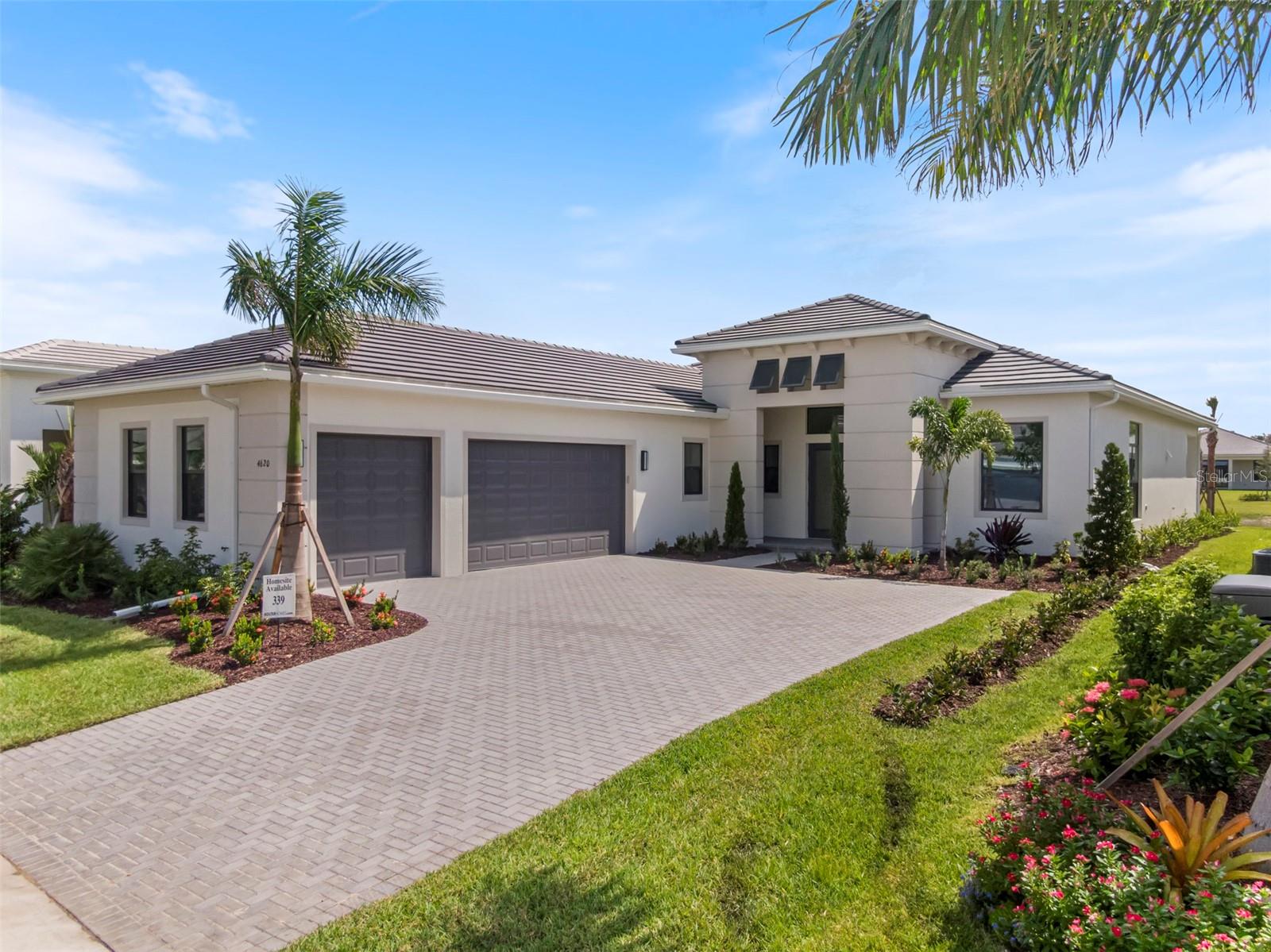 Under Construction. ***NEW CONSTRUCTION*** Welcome to the Renoir at Artistry Sarasota, an elegant, open-concept home featuring 2 bedrooms, 2.5 baths, a club room, den, and a spacious 3-car garage. Located on a scenic waterfront homesite, this home offers privacy and comfort with impact glass throughout, a privacy wall, and an extended lanai with summer kitchen rough-in and pool-ready setup.
Inside, enjoy soaring tray ceilings, transom windows, and luxury laminate flooring in main living areas. The gourmet kitchen features a 36” Café gas cooktop, built-in wall oven, quartz countertops, crown-molded cabinetry, stainless steel undermount sink, and full-extension drawers.
A double glass front door entry included with a washer and dryer, laundry tub rough-in, and thoughtfully placed floor outlet add function to the home’s stylish design. With nearby nature trails and water views, this home offers the best of Florida living in a premier gated community.