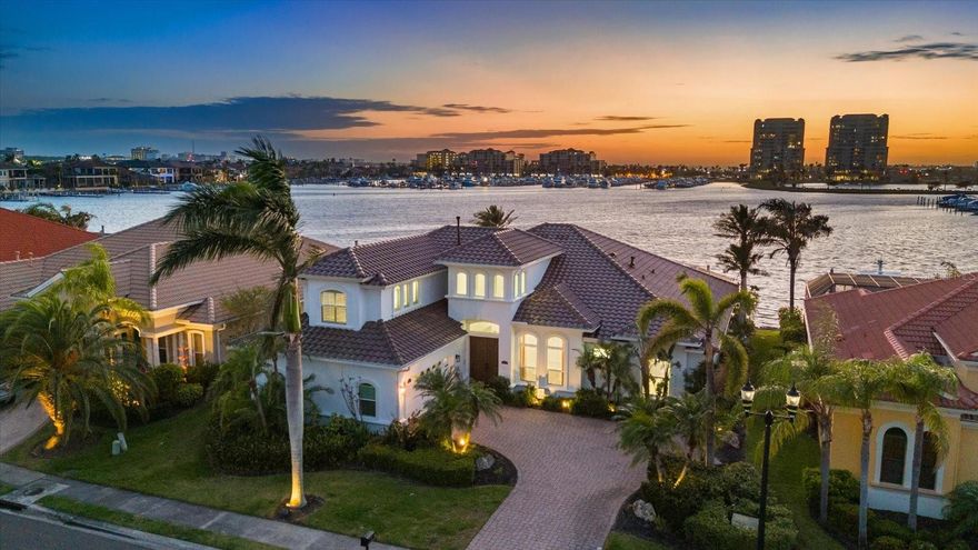 Welcome to Riviera Dunes, an exclusive gated waterfront enclave known for its luxury lifestyle and ideal location. Tucked within this private community lies a beautifully modernized residence, fully reimagined in 2022 to offer the perfect blend of comfort, and coastal elegance. From the moment you step through the front door, soaring ceilings and a light-filled two-story foyer set the stage for refined design and exceptional craftsmanship. European white oak flooring flows throughout, complementing designer-selected tilework in the spa-like baths. The chef’s kitchen is a incredible, featuring custom cabinetry with pull-outs, smart storage solutions, and top-tier appliances—including a Sub-Zero refrigerator and a natural gas Wolf range. A butler’s pantry with a wine cooler, second dishwasher, and additional storage adds function, making entertaining effortless. Walls of impact-rated sliding doors invite natural light and open to a limestone pool deck, where a spacious covered lanai with pool and spa offers the ideal backdrop for relaxing or entertaining as the sun sets over the water. The primary suite is a serene retreat with expansive water views, a luxurious bathroom featuring dual vanities, a zero-entry shower, and a soaking tub, and generous walk-in closet space. A bright home office or den offers a peaceful and bright space to work or unwind. For the boating enthusiast is the private 60' dock located in the protected harbor of Riviera Dunes—widely regarded as one of the safest harbors on Florida’s southwest coast. Every element of this home has been meticulously updated, including a new tile roof in 2023, making it truly move-in ready. Reach out today or your private tour!