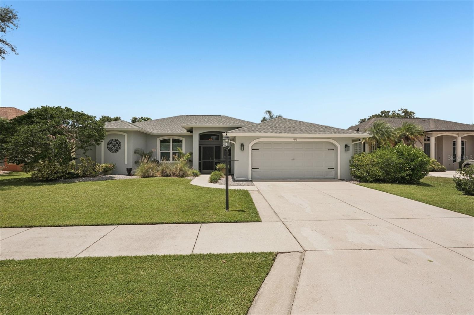 So much to offer!! The Meadow Walk community is peaceful, with many people enjoying their backyards for summer grilling. Your choice, the neighborhood can be social or quiet. Just across from Celery mountain and Big Cat Habitat. Many walking trails around celery fields with an abundance of nature for an enjoyable active lifestyle. Close to town everything is just a short car ride to grocery stores, beaches, sports, boating, fishing and so much more. This very desirable home has been meticulously taken care of and upgraded. New PGT hurricane window and sliders new (2023) New LVP and carpet flooring in 2023. New Gutters (2023), AGDO (2022). Pool cage painted, new screens and stainless steel screws(2022) New shingle roof in 2021. Both bathrooms have been updated plus a new sizeable dual faucet walk-in shower in the primary bath. Pool bath shower updated with glass enclosure and tile as well. Open concept kitchen off the dining room has breakfast bar, island, working desk and window for peeking out front. Kitchen and cabinets were recently painted. AC is from 2018 but still under warranty. Just pay for labor. New duct added to Primary bedroom. Owners are leaving spa off the private lanai area (35'x30') with views of the tranquil lake. Use the outdoor heated shower after a long dip in the heated pool (26'x15'). Daughter's garden just off lanai can be kept for the chef in you. All lakes have been reinforced.