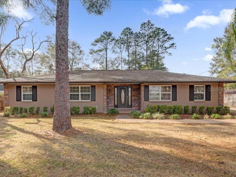 Welcome to your dream home! This beautifully 4BR/2BA pool home sits on nearly1/2 acre and offers the perfect blend of charm and comfort. Step into an airy, open layout with laminate floors, a cozy fireplace, and a bright living space overlooking an oversized 20x40 pool. The updated kitchen features stainless steel appliances, soft-close cabinets, butcher block counters, and a walk-in pantry. Enjoy three
spacious guest rooms and a double-sink bath. The private master suite boasts French doors to the screened
lanai, a walk-in closet, and a gorgeous bath with dual vanities. Relax at the poolside or entertain with ease in your backyard oasis. 2-car garage with built-in storage. Recent updates: Roof (2017), Windows (2017), HVAC (2014), Pool Pump (2022). Move-in ready!