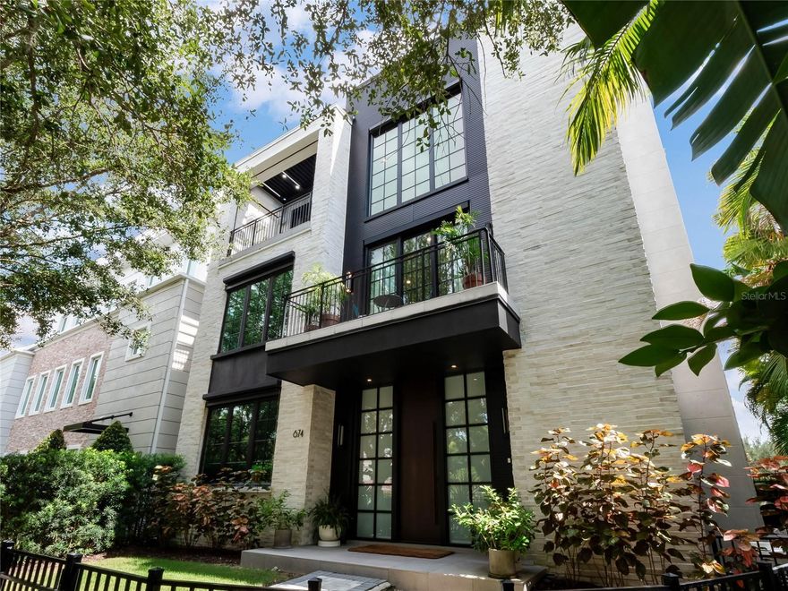 This stunning DETACHED LUXURY, URBAN, ELEVATOR home, meticulously crafted by the renowned Phil Kean Design Group, presents itself as an opulent haven in the heart of Downtown Winter Park, FL. With innovative modern architecture & state-of-the-art technology, this magnificent residence has been classified as a Net Zero/-16HRZ energy rating, producing more power than it uses, making it one of the most eco-friendly homes on the market. Designated as a showcase home for the National Association of Home Builders & International Builders Showcase, the interior spanning across three levels, boasts elegance coupled with unsurpassed luxury. The grand entrance on the FIRST level welcomes you with an exquisite gallery, adorned with conversational spaces, an en-suite bedroom, an office or bedroom, a mud room with doggie door, fenced dog run, & a spacious oversized 3 car garage equipped with an electric car charger and overhead storage system. Ascend to the SECOND level and discover the primary owner's suite, an absolute masterpiece, with a spa-like bath fitted with a steam shower, a lavish & posh walk-in closet with showcase lighted storage & a storage island.   A workout room/additional bedroom) with a full-sized sauna adds to the retreat-like atmosphere of this floor.  Here there is a large loft/flex space perfect for a lounge or office and a beautiful laundry room with double LG washer & dryer sets and a phenomenal dry-cleaning closet, the next must have appliance! The TOP level of this home is a showstopper. With an open-concept design and breathtaking green views from every angle, this luxurious and expansive area will be the perfect place to entertain guests or unwind after a long day. This level features a well-lit dining area, a stunning wet bar, a warm and cozy fireplace, 2 outdoor balconies ideal for basking in beautiful views and enjoying Florida’s outdoor living. The exquisite kitchen, hailed as the "Best Kitchen in Country 2020," will be a chef’s dream and is fitted with state-of-the-art Wolf & Signature appliances, including a 48-inch dual fuel range and 4 Wi-Fi-enabled smart ovens & a sous vide cooking system for perfectly cooked meals every time. The kitchen also features a built in Espresso Maker for a perfect coffee to compliment the beautiful surroundings. Lighted, Temperature-controlled wine towers built to impress any wine connoisseur and boast ample space for up to 600 bottles of your favorite vintage. The home is unique in every sense of the word. With its 14-foot ceilings, 12-foot external doors, symphony of natural light, and awe-inspiring views, the home is a haven of unparalleled sophistication. The floating walnut staircase with unique underlighting will surely captivate your attention & add a touch of class to the space. The elevator with leather walls and brass flooring provides easy access to all three floors and adds to the home's elegance. Additional features, such as a whole-home generator, state of the art home security system, Panasonic air filtration system, 2 tankless, gas water heaters, Control4 Home automation system, outdoor terraces, summer kitchen, and automated louvered porch roofing system, solar panels on roof, & remote-controlled balcony screens will deliver convenience and peace of mind to all.  Located in Hannibal Square's dining and shopping district & a short 3 block walk to Park Avenue for entertainment, dining, shopping, museums and galleries, and Central Park for picnics, strolls and Festivals.