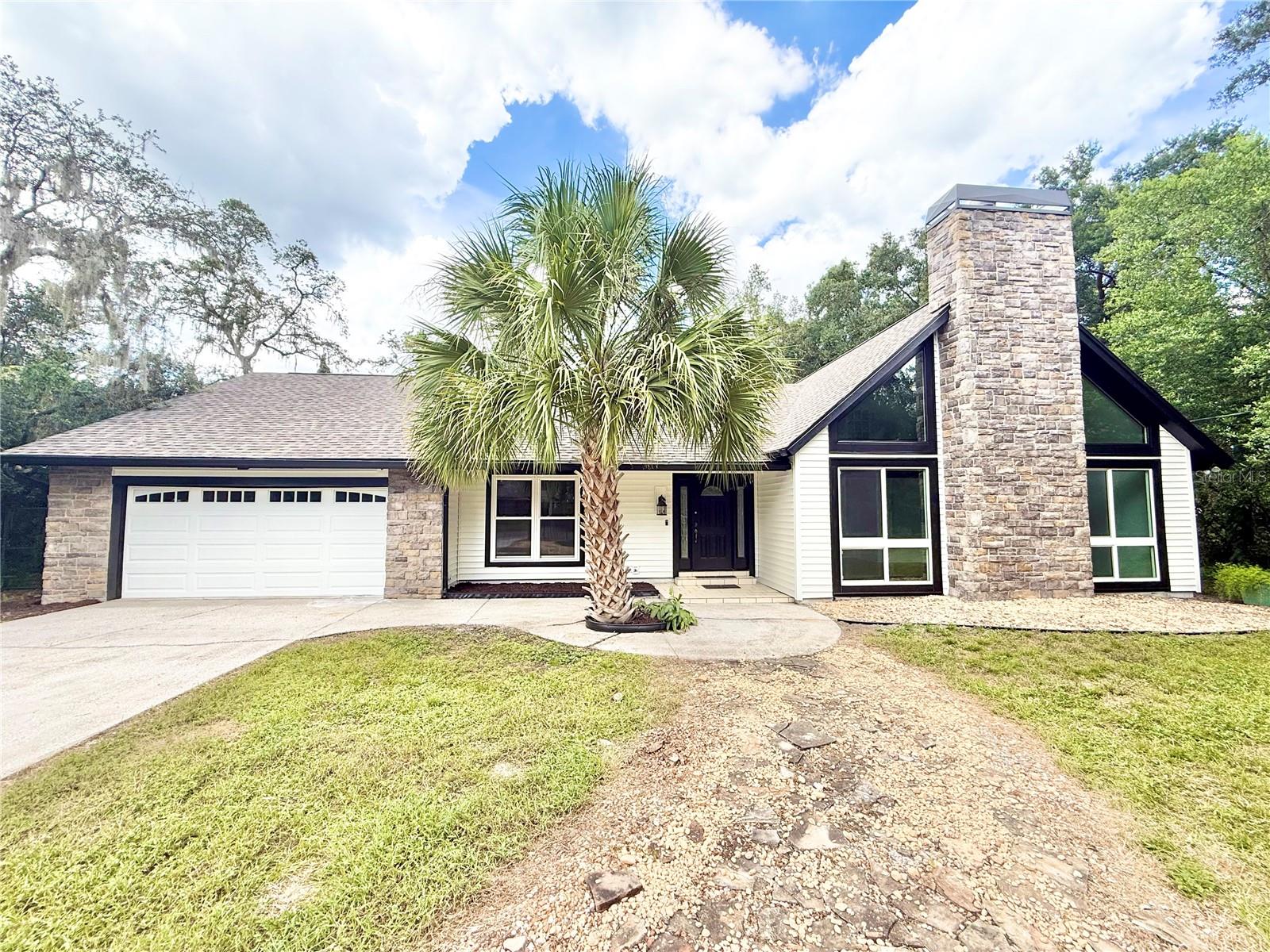 NO HOA! FLOOD ZONE X! SELLER FINANCING AVAILABLE as well as a RENT-TO-OWN program. Spacious, renovated 3-bedroom, 3-bathroom, 2-car garage POOL HOME on a LARGE FENCED 0.26-ACRE LOT in one of the most premier neighborhoods in Tampa, centrally located to the airport, downtown Tampa, USF, UT, Gulf beaches, and St. Petersburg, plus all the restaurants, shopping, schools, hospitals, International Mall, and more nearby—this area has it all for those looking to invest or live in sunny Florida! This modern rustic lodge-style home has an extensive amount of updates and feels like paradise with the screened-in pool with a massive lanai, spacious and freshly landscaped lot with a small pond in the front, and its unique architecture featuring a wood-burning fireplace, vaulted ceilings with beams, and the combination of siding and stone throughout the exterior. It is an open floor plan with plenty of natural light, perfect for entertaining or having enough room for the whole family, especially with over 2,000 sq. ft. of living space! Both the primary bedroom and the second bedroom on the first floor have walk-in closets and their own bathrooms with sliding doors that lead directly to the pool. Updates include: AC (2020), ROOF (2021), newer pool equipment, well pump (2022), septic pumped and serviced (2021), heat pump water heater (2021), water softener system, quartz countertops, white cabinets, new stainless steel appliances, new LVP throughout, fresh paint inside and out, remodeled bathrooms, updated pool deck, and not to mention all front-facing windows are impact resistant, with the remaining being dual-paned and newer. The primary bedroom and 3rd bedroom have mini-split systems that are around 6 years old. This home has been meticulously maintained and is move-in ready—purchase this home with confidence and ease! This property is being sold as-is. All information provided is intended to be accurate but is not guaranteed. Measurements and specifications to be verified by buyer or buyer's agent. Listing agent has equitable interest. Schedule your showing today for your piece of Florida paradise!