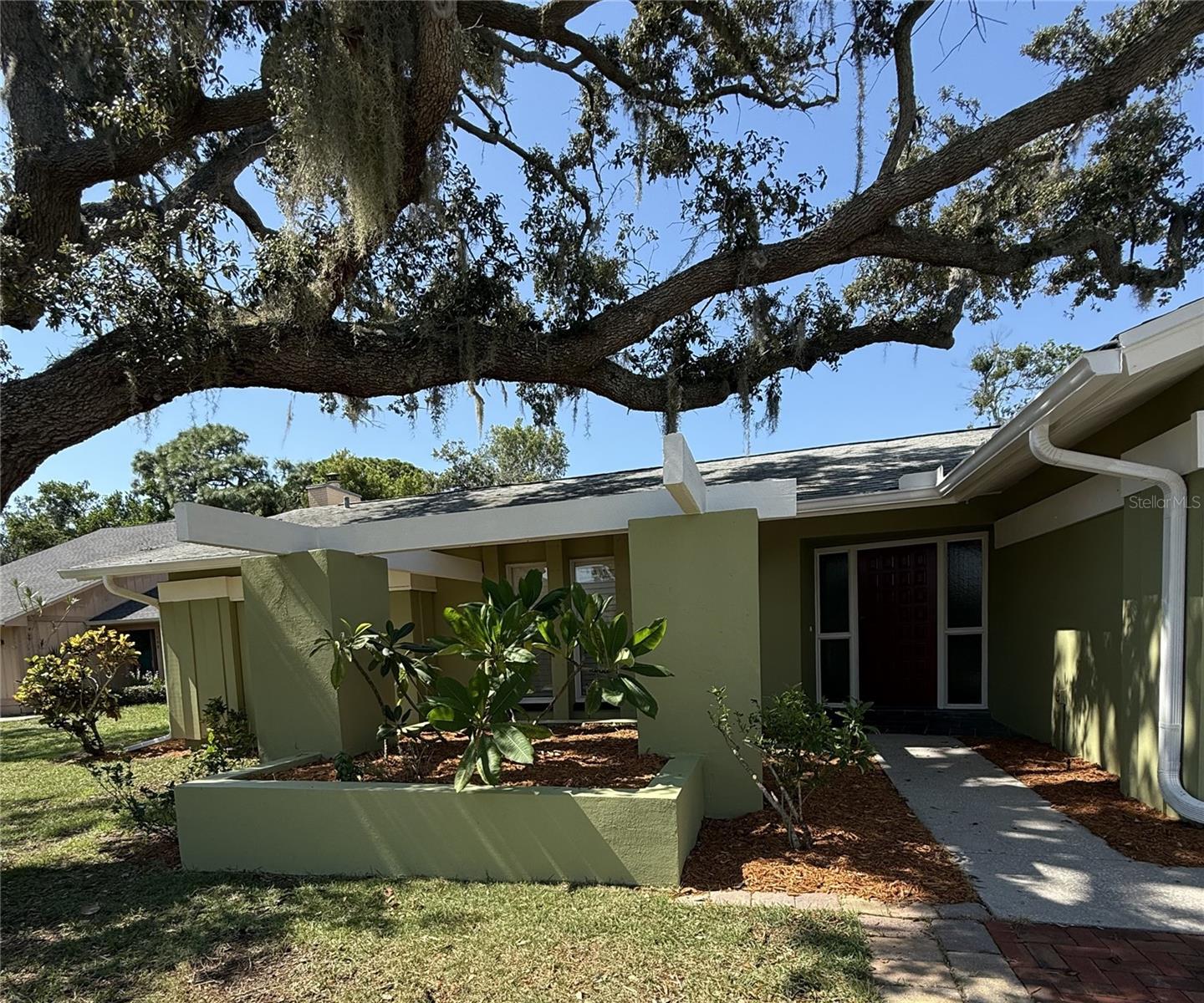Beautiful, completely updated (4) Bedroom (2) bath Custom home, with 1978 sf AC space & 2742 sf under roof that is only a short walk
to beaches with Gulf access for kayaks at end of the street. Big, private, completely fenced home with pretty yard & fruit trees. This
terrific home is "high & dry", with NO FLOODING, EVER! Spacious kitchen & family room featuring a tremendous brick natural
fireplace. Updated kitchen has solid oak custom cabinets, granite counter tops & huge island for exra dining space, plus large
eat-in-kitchen area.
Kitchen also has 2025 SS Frigidaire refrigerator with ice & water in door, 30" black glass stove & new Frigidaire dishwasher, plus
newer micro-wave & disposal. Beautiful plantation shutters thru out the home add to the charm & beauty of this property. Large
entrance/foyer into the huge living room area that looks thru to the great screened porch opening up to a totally wood fenced back yard. Home has been totally renovated, painted & has complete gutter system with Leaf Guard protection. Spacious (2) car garage with storage area, Genie garage door opener, wall sink & attic access.
This is a split floor plan with Master Bedroom & bath looking out to the private patio & pretty back yard & (3) more nice sized bedrooms
on opposite side of home with 2nd bath. The Master bath has large walk in tiled shower, glass door, oak cabinet with granite counter
top & ceramic tiled floor. Tons of storage space in the (3) bedrooms with custom built shelving in all bedrooms that add to the generous
storage. Roof was replaced by Kontos Roofing in 2018 & new AC unit was installed in 2016 with Air Purifier added to the Air handler. Lighting is exceptional with newer ceiling fans & lighting in all rooms plus rocker switches. Laundry room includes front load LG washer with pedestal, dryer, storage closet & built-in, fold down laundry board in wall.
This home is a find in beautiful neighborhood within minutes from both the Tarpon Springs Middle & Elementary Schools, and minutes
from historic Downtown with tons of shopping & the famous Sponge Docks with working Sponge divers.
Home is ready to move into with plenty of room to add a pool & a great floor plan for you and/or your family!