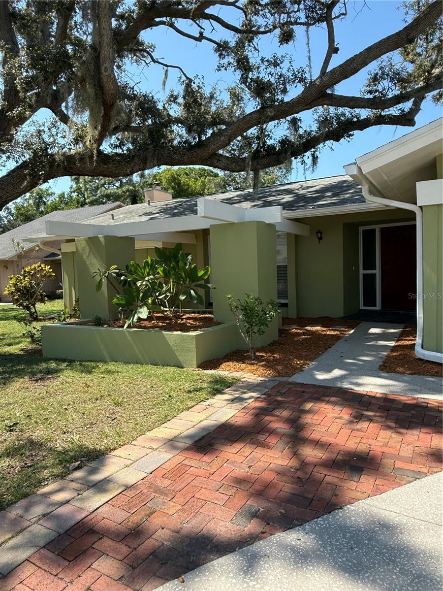 Beautiful, completely updated (4) Bedroom (2) bath Custom home, with 1978 sf AC space & 2742 sf under roof that is only a short walk
to beaches with Gulf access for kayaks at end of the street. Big, private, completely fenced home with pretty yard & fruit trees. This
terrific home is "high & dry", with NO FLOODING, EVER! Spacious kitchen & family room featuring a tremendous brick natural
fireplace. Updated kitchen has solid oak custom cabinets, granite counter tops & huge island for exra dining space, plus large
eat-in-kitchen area.
Kitchen also has 2025 SS Frigidaire refrigerator with ice & water in door, 30" black glass stove & new Frigidaire dishwasher, plus
newer micro-wave & disposal. Beautiful plantation shutters thru out the home add to the charm & beauty of this property. Large
entrance/foyer into the huge living room area that looks thru to the great screened porch opening up to a totally wood fenced back yard. Home has been totally renovated, painted & has complete gutter system with Leaf Guard protection. Spacious (2) car garage with storage area, Genie garage door opener, wall sink & attic access.
This is a split floor plan with Master Bedroom & bath looking out to the private patio & pretty back kyard & (3) more nice sized bedrooms
on opposite side of home with 2nd bath. The Master bath has large walk in tiled shower, glass door, oak cabinet with granite counter
top & ceramic tiled floor. Tons of storage space in the (3) bedrooms with custom built shelving in all bedrooms that add to the generous
storage. Roof was replaced by Kontos Roofing in 2018 & new AC unit was installed in 2016 with Air Purifier added to the Air handler. Lighting is exceptional with newer ceiling fans & lighting in all rooms plus rocker switches. Laundry room includes front load LG washer with pedestal, dryer, storage closet & built-in, fold down laundry board in wall.
This home is a find in beautiful neighborhood within minutes from both the Tarpon Springs Middle & Elementary Schools, and minutes
from historic Downtown with tons of shopping & the famous Sponge Docks with working Sponge divers.
Home is ready to move into with plenty of room to add a pool & a great floor plan for you and/or your family!