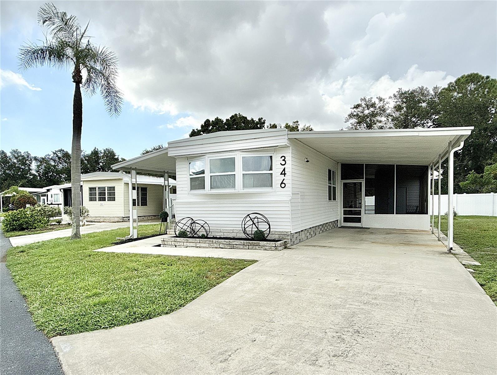 Incredible value for well-maintained 2 bed/1 large bath remodeled home located close to community park and boat ramp. Oversized lot set against the perimeter fence creates a quiet retreat! The features are many: Home has almost 800 sq ft of living space plus a 300 sq. ft screened porch creating a peaceful oasis; large kitchen and bath with walk-in shower remodeled in 2016, water heater is 2017, roofover in 2016, 2024 mini splits so no ductwork underneath; 2024 spray foam vapor barrier protects the subflooring; new 3/4" subflooring and 1/2" painted plywood flooring creates a very solid base; and indoor laundry with stackable washer and dryer. Roomy shed for storage. Recent 4 pt inspection available. Transferable flood policy with 2 years free coverage available for buyer for extra peace of mind. Home is located in popular 55+ dog friendly community located only 10 mins to downtown St. Petersburg. 2 dogs or cats up to 35 pds are welcomed. 2 pets total each household. Price includes share for the lot and ownership in the Co-op. Home would make a great full-time residence, affordable vacation home or investment property as renting is allowed with 2 month minimum. Low monthly maintenance fee of $380 includes water, sewer, trash pick up, lawn mowing, 24 hr manned gate, private streets, seawall maintenance and all amenities including fitness center, heated pool, clubhouse, billiards and so much more! This is the affordable retirement home that you've been waiting for!