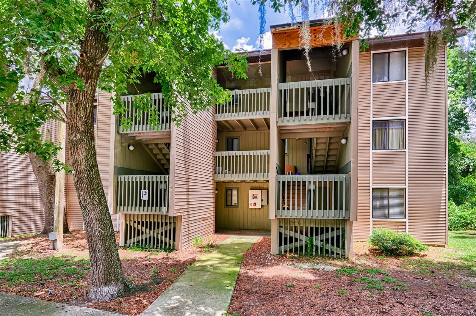 Welcome to this serene 2-bedroom, 2-bathroom first-floor condo nestled in a peaceful, wooded setting. Each bedroom features its own private en-suite bathroom, offering comfort and privacy for residents (great for roommates) or guests alike. Enjoy picturesque views of mature trees from the living room and back bedroom, creating a tranquil atmosphere that feels miles away from the city – yet you're just minutes from the University of Florida, UF Health/Shands, Downtown Gainesville, and local shopping and dining. The unit boasts no carpet, with durable tile and luxury vinyl plank flooring throughout for easy maintenance and a clean, modern feel. Major updates include a new water heater (2022) and new HVAC system (2023), and the roof was recently replaced by the HOA – offering peace of mind for years to come. Treehouse Village offers a range of community amenities, including a sparkling swimming pool, a fitness center, and ample open parking for you and your guests.
Whether you're a first-time homebuyer, student, medical professional, or investor, this move-in-ready condo offers unbeatable value and location. Don't miss out on this gem – schedule your showing today!