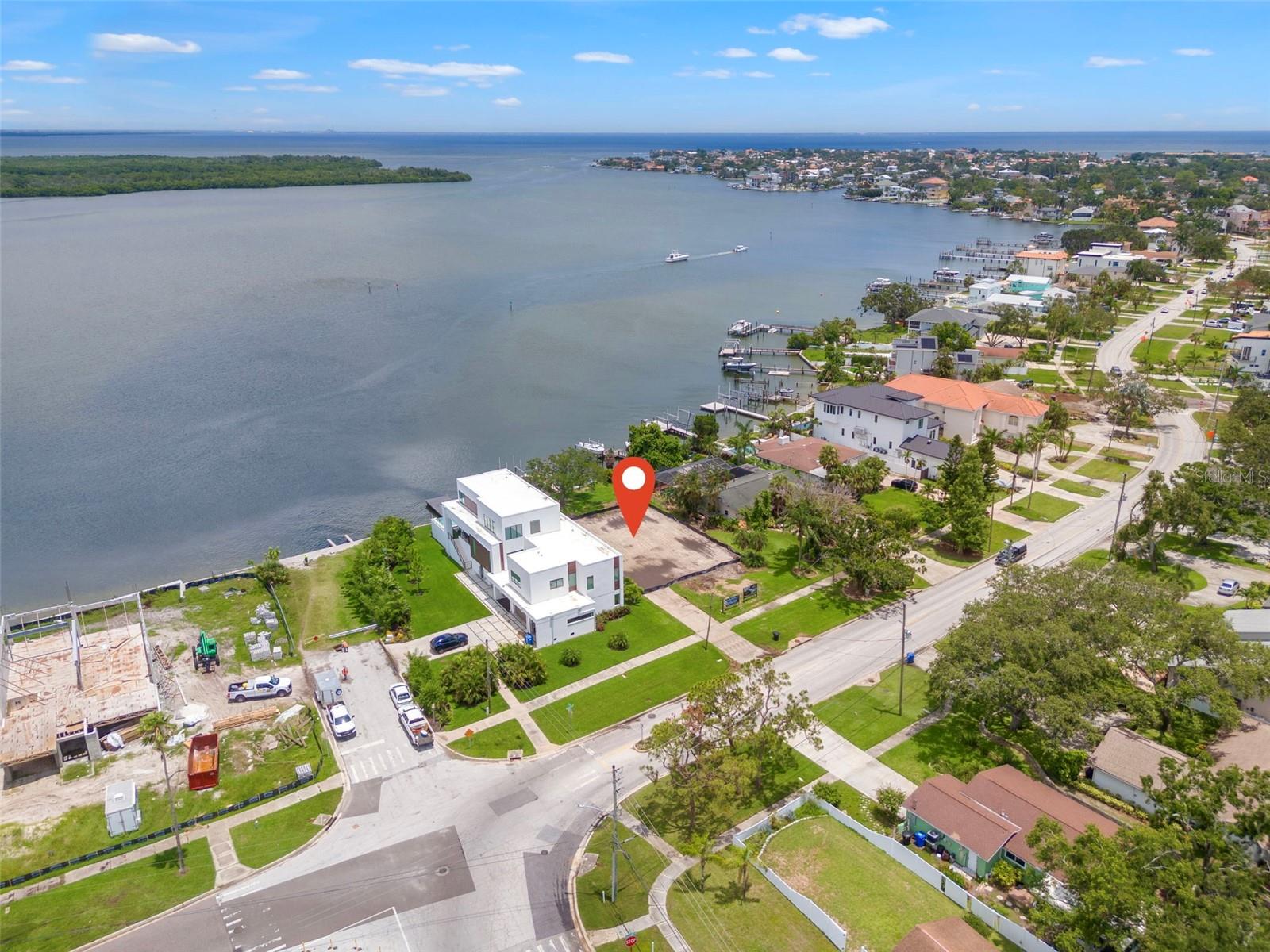 BIG VIEWS and DEEP WATER. On the market for the first time in over 50 years. This property is larger than most at over a 1/4 of an acre and has 69+ feet on the water. This is a rare opportunity to build your dream home next to and amongst other new construction homes. There is a seawall and dock in place with a newer boat lift, plus two additional sets of davits. This is a DEEP WATER lot with full boat lift operation, even at low tide. NO BRIDGES into Tampa Bay so your boat size or sailboat are not restricted. The property’s premier location is a big advantage over most being located right next to 62nd Ave. High tide? No problem, you’re not going to be driving through salt water in the street to get home. This location offers attractive ingress and egress and is a benefit over other properties located deep into Shore Acres, Snell Isle, Venetian Isles, Bayshore, etc. Beyond the generous sized lot, it feels even bigger due to an additional 36-feet (MOL) right-of-way between the street and the front property line. This property is the lowest priced expansive view, direct waterfront land option (on a per SF basis) in all of NE St. Petersburg.