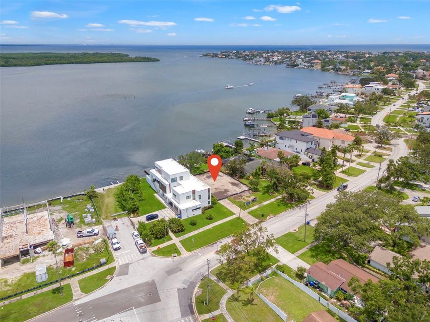 BIG VIEWS and DEEP WATER.  On the market for the first time in over 50 years. This property is larger than most at over a 1/4 of an acre and has 69+ feet on the water. This is a rare opportunity to build your dream home next to and amongst other new construction homes.  There is a seawall and dock in place with a newer boat lift, plus two additional sets of davits.  This is a DEEP WATER lot with full boat lift operation, even at low tide.  NO BRIDGES into Tampa Bay so your boat size or sailboat are not restricted.  The property’s premier location is a big advantage over most being located right next to 62nd Ave.  High tide?  No problem, you’re not going to be driving through salt water in the street to get home.  This location offers attractive ingress and egress and is a benefit over other properties located deep into Shore Acres, Snell Isle, Venetian Isles, Bayshore, etc.  Beyond the generous sized lot, it feels even bigger due to an additional 36-feet (MOL) right-of-way between the street and the front property line.  This property is the lowest priced expansive view, direct waterfront land option (on a per SF basis) in all of NE St. Petersburg.