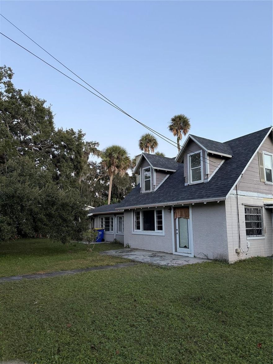 Discover this rare grandfathered investment opportunity on a corner parcel at 226 Wildwood Ave, Edgewater, FL 32132, Long term or Short term rentals allowed- No minimum or license for STR in Edgewater, featuring a new 2024 roof, two ground-floor 1-bedroom, 1-bathroom kitchen, duplex units ideal for steady rental income, and a versatile upstairs bonus unit kitchenette, full bath, bedroom, living area with private exterior stairs—perfect for owner occupancy, on-site manager use, the property includes multiple driveways for convenient access and parking, a privacy-fenced rear yard, and hot/cold hookups for a laundry area in the shared exterior side porch; situated on a quiet residential street just minutes from the Intracoastal Waterway, boat ramps, parks, New Smyrna Beach, I-95, and local shopping, schools, this multi-family gem offers separate entrances, ample parking, low-maintenance exterior, and excellent cash flow potential in the desirable Volusia County market—live in the bonus space while tenants cover the mortgage or rent for maximum returns; property sold as-is with information deemed reliable but not guaranteed buyer to verify all details, AS IS Cash only