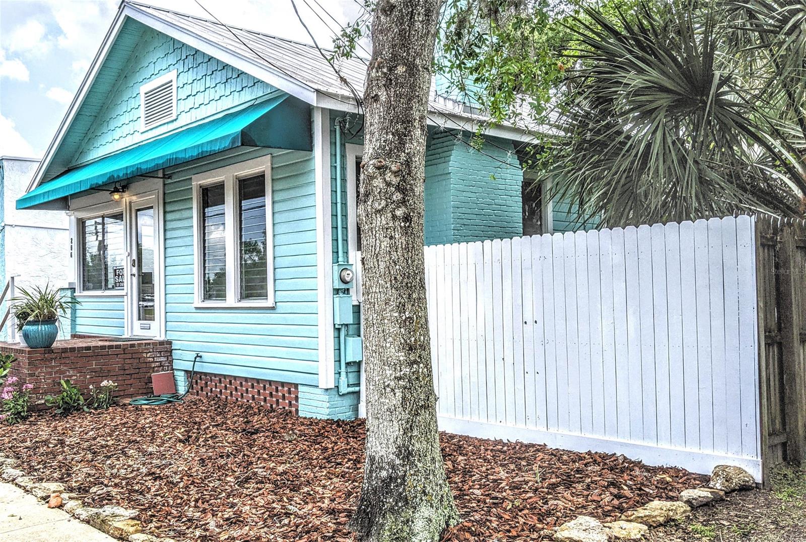 OPEN HOUSE- COME SEE THE NEWEST GORGEOUS LISTING JUST 5 MINUTES FROM FLAGLER AVENUE AND THE BEACH, 1 MINUTE FROM CANAL STREET AND THE CITY
BOAT MARINA, WHERE YOU CAN RENT BOATS OR GO OUT ON A FISHING CHARTER....great bait shop and waterfront restaurant.
LOCATION- Don't miss out on this 2 bedroom 1.5 bathroom, plus bonus office, Beach Bungalow! This pristine home has the very best LOCATION, LOCATION LOCATION! Live and play here with boutique shopping, fabulous fine dining, local craft beer and casual restaurants. Weekly Saturday Farmers market with the best produce, plants and so much more. Don't forget the monthly classic car show on Canal Street, on every second Saturday.
ZONING- This home also has the most desired zoning in New Smyrna Beach. Zoned MU/Commercial, this home is in the short term rental area. So this house can legally be used as a AirBnB, available for nightly rentals, weekly, monthly...whatever you would like. Live in it, rent it, run a business or all of the above.
UPDATES- The most recent updates in 2020 and 2021 are: Shiplap siding in the office and main bedroom, new ac condenser, new ceiling fans with remote control, new lighting fixtures and faucets in bathrooms and kitchen, new stove, new door handles and knobs, fresh white paint through entire home, exterior of home painted, all fences painted, new easy to take care of landscaping and mulch. New white aluminum custom handrailing on front porch. Updates over the past years include metal roof, hardwood floors, custom 6 inch baseboards, custom wood cabinets, granite hearth with brick wood burning fireplace. In the rear of the house is a safety ramp to easily access the house.
EXTERIOR- Backyard features include 2 storage sheds, 16x8 and 8x6. Privacy fence around almost entire property. Brick paver driveway with a brick paver seating area under the shade trees.
Measurements are approximate, Buyer to verify all information. ;Water: City