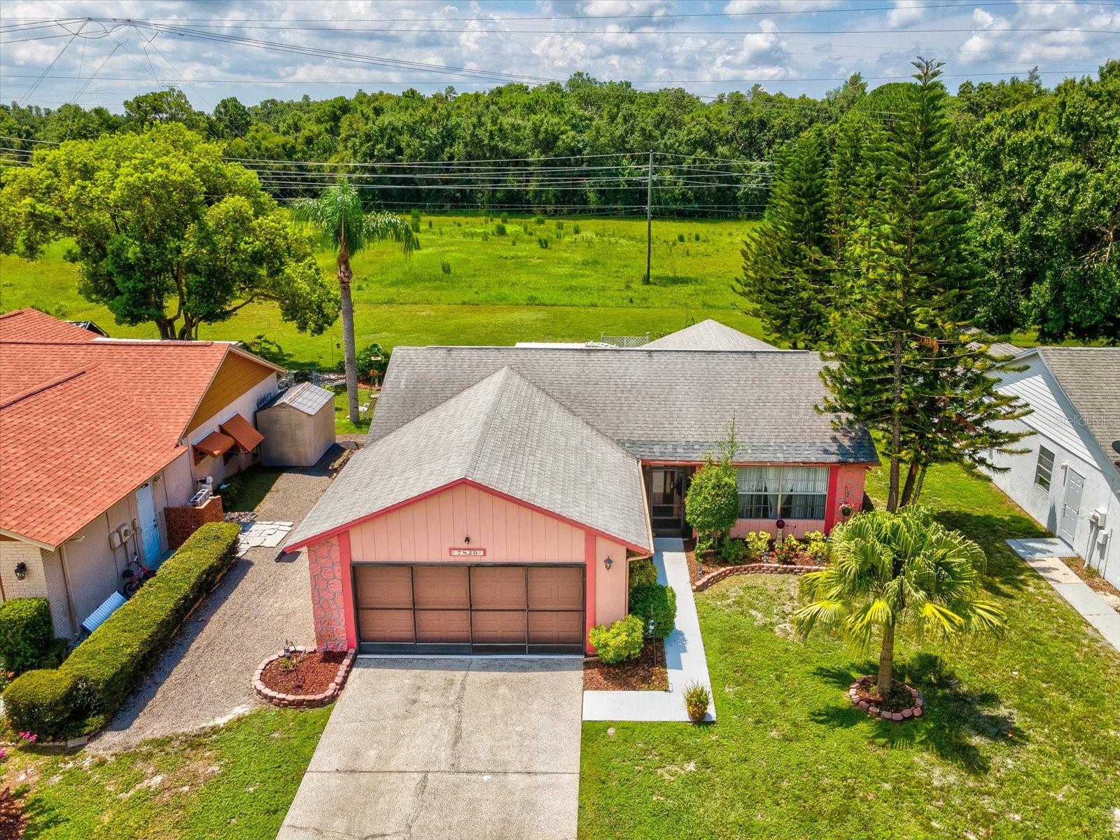 NEW ROOF WILL BE INSTALLED PRIOR TO CLOSING AT SELLER'S EXPENSE! This is a well maintained 2 bed 2 bath home with no rear neighbors. The spacious primary bedroom includes a walk-in closet and a private bath with a walk-in shower. There is a large family room in the rear of the house that gives you access to the covered and screened lanai that also has vinyl covered windows. The home has vertical blinds throughout. The two car garage includes sliding screen doors across the front. The HVAC system was replaced in 2023. This home is a great location near excellent schools, shopping, hospitals, restaurants, air ports and much more!