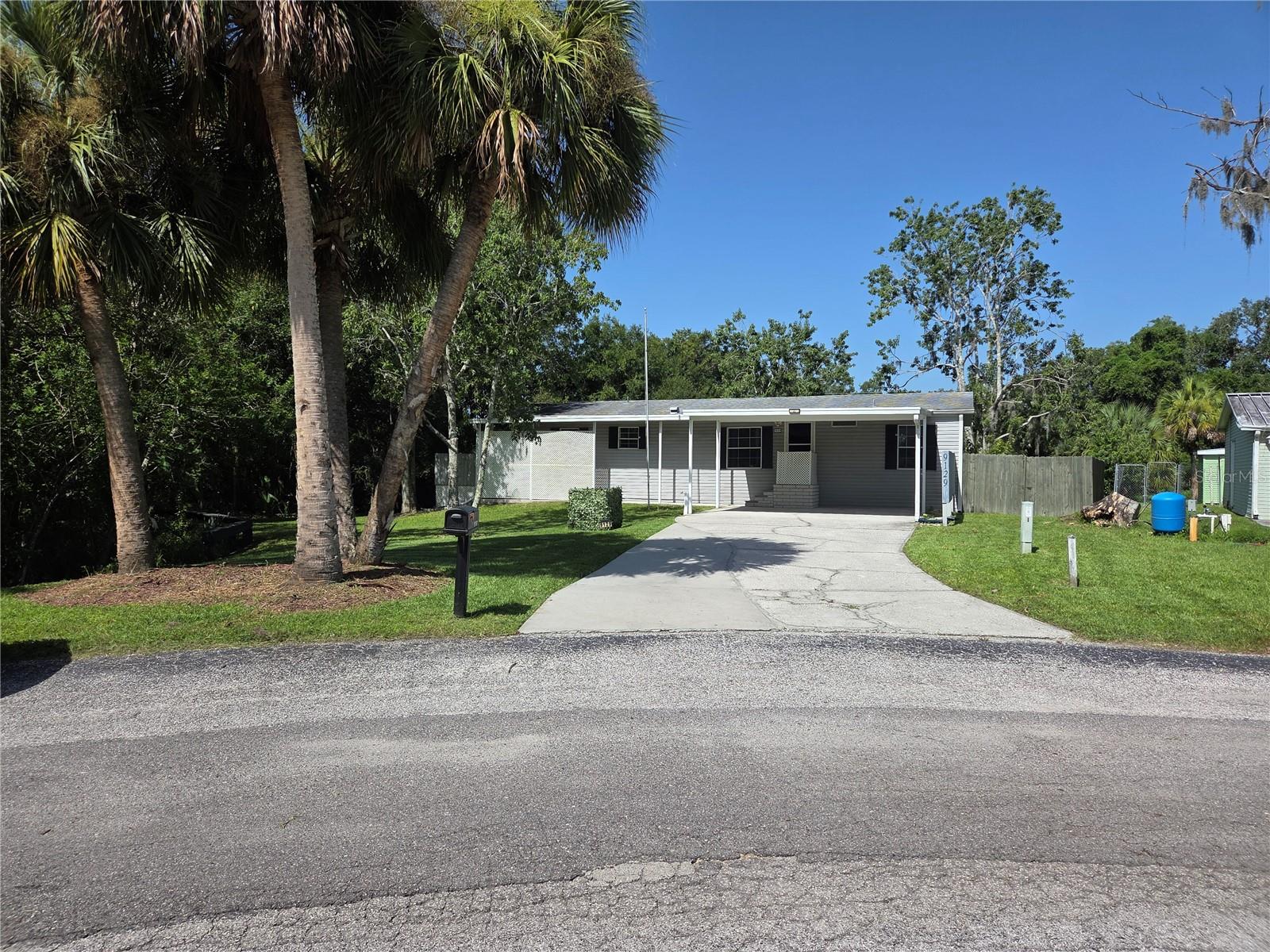 Huge yard, well maintained 3/2 Mobile Home. 10X12 Storage shed in back. A/C is 4 years old. Fully fenced back yard with gated road access. Kitchen cabinets were updated 5 years ago. Water filter and softener included. Washer/Dryer included. Riding mower, push mower and a few yard tools included.