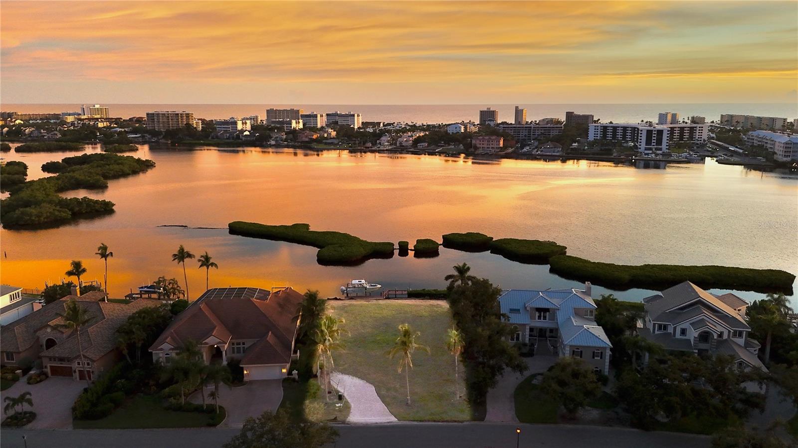 Rare Waterfront Lot with Direct Intracoastal and Easy Gulf Access. A Boater’s Dream in Baywood Colony.
Discover a truly unique opportunity to build your custom waterfront retreat on this prime 0.36-acre lot in the highly desirable Baywood Colony. With direct views of the Intracoastal Waterway and breathtaking western sunsets, this Premium Lot offers the perfect combination of privacy, water access, and location.
This exceptional lot is already equipped with a private dock, a 16,000 lb boat lift, a jet-ski lift, and a dredged passage—providing seamless access to the Gulf with no fixed bridges. It's a rare find for boating enthusiasts seeking convenience and open water freedom.
The lot was previously improved with a home, and existing utilities remain on-site, potentially qualifying the buyer for reduced or waived impact fees for new construction.
A standout feature is the transferable mangrove trimming permit, ensuring you’ll always enjoy unobstructed views across the Bay, a valuable and uncommon advantage for waterfront living.
Ideally located just minutes from downtown Sarasota, Siesta Key Beach, and Sarasota Memorial Hospital, this homesite offers quick access to world-class dining, shopping, healthcare, and cultural experiences, all while providing a peaceful and private retreat.
This is one of the few remaining waterfront parcels offering this level of access, infrastructure, and scenic beauty. Don’t miss your chance to create your dream home in one of Sarasota’s most coveted coastal enclaves.