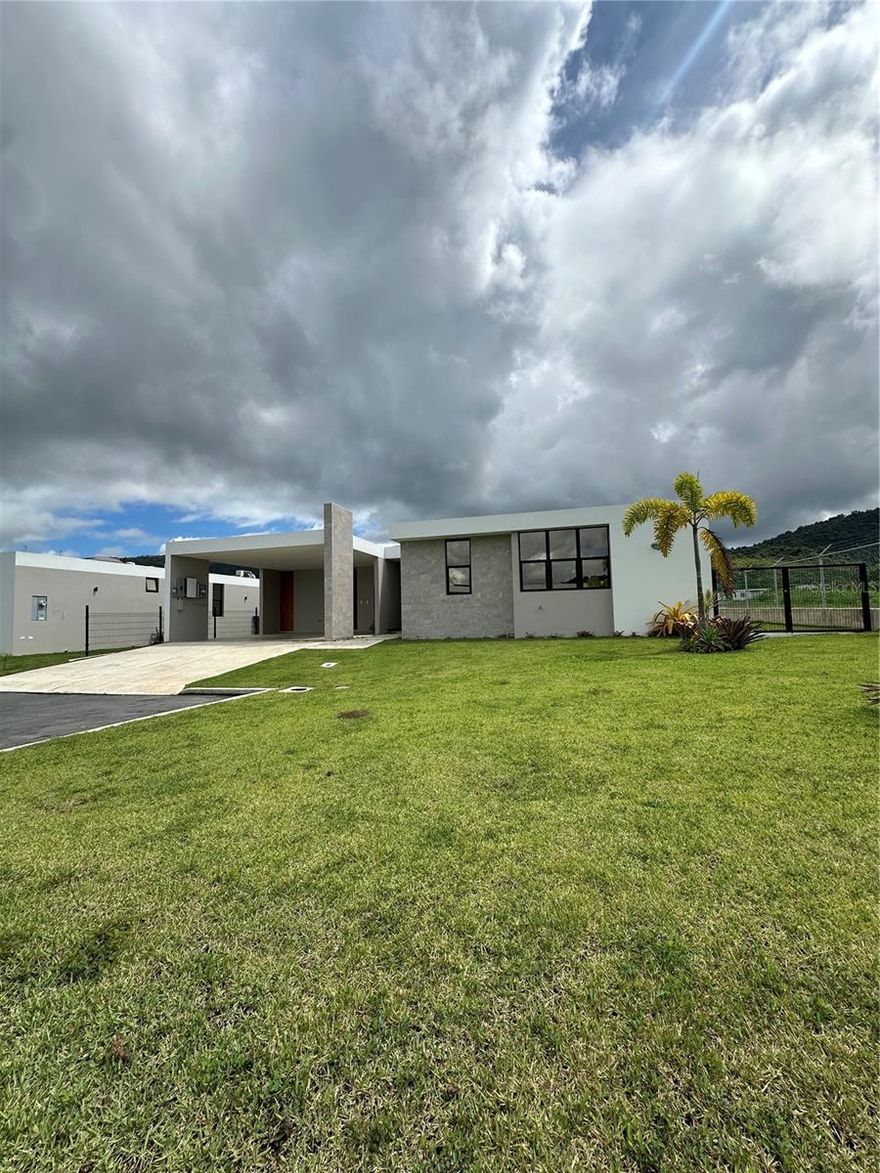 Elegant Corner Residence in River Terrace – 4BR | 2.5BA | Cul-de-Sac Lot

Welcome to a beautifully designed one-level, four-bedroom, 2.5-bathroom home located on a corner lot at the end of a quiet cul-de-sac in River Terrace, part of the sought-after Ciudad Jardín community in Gurabo. With approximately 1,900 sq.ft. of living space and set on a 592.27 sqm lot, this thoughtfully crafted residence blends comfort, function, and energy efficiency.

Step into a spacious open layout with soaring 11-foot ceilings in the main living area, creating an inviting and airy atmosphere ideal for relaxing or entertaining. The modern kitchen features quartz countertops, a center island, and a walk-in pantry. The primary suite includes a walk-in closet and a well-appointed en-suite bathroom with double vanity and fully tiled shower. 

Notable features include:

Double carport with storage

Laundry area

80-gallon solar water heater

600-gallon cistern

22 solar panels with two Tesla batteries

Generator connection

EV-ready outlet for a golf cart

Pre-wired voice and data throughout

River Terrace offers an exceptional lifestyle with access to:

Tennis, pickleball, and beach tennis courts

Racquet Club 

Community pool

Fully equipped gym and wellness center

Basketball courts and playgrounds

Convenience store and restaurant

Zahara Salon, SPA & Esthetique

Activity center

School within the community: American Academy

This is a rare opportunity to own a move-in ready home in one of Gurabo’s most complete and vibrant communities. Schedule your private tour today!