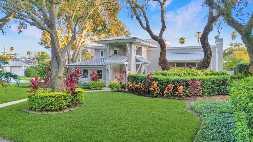 Luxury Living in the Heart of Belleair
Nestled on prestigious Park Avenue, this stunning Key West-inspired residence blends timeless elegance with modern luxury. Move-in ready and masterfully designed, it offers 4 spacious ensuite bedrooms, 4.5 baths, and nearly 3,000 sq ft of thoughtfully curated living space—perfect for refined everyday living and exceptional entertaining.

Completely rebuilt from the ground up in 2010 and updated in 2022, this stunning home sits 50 feet above sea level with hurricane-grade windows and doors, offering peace of mind with no flood insurance required.

Step through the grand two-story foyer into a sun-drenched Great Room featuring a dramatic 12-foot fireplace wall and floor-to-ceiling sliding glass doors, seamlessly connecting the indoors with lush outdoor living. A striking open floating staircase anchors the space as a bold architectural centerpiece.

The newly updated gourmet kitchen impresses with custom cabinetry, granite countertops, an oversized island, high-end appliances, and a Viking gas cooktop. A custom wet bar and beverage room with integrated lighting and granite surfaces elevate your entertaining game.

The luxurious primary suite is your personal retreat—fully remodeled with elegant finishes, designer lighting, dual sinks, a soaking tub, and a spa-like walk-in shower. A custom walk-in closet and private balcony with sunset views complete the suite.

Outside, the tropical oasis continues with a PebbleTec pool, heated spa, covered lounge area, and total privacy. Whether entertaining guests or enjoying quiet evenings under the stars, this backyard sanctuary delivers.

Additional upgrades include a metal roof, oversized two-car garage, energy-efficient HVAC with UV filtration, custom closets, alarm system, and a new hot water tank.

Located just one block from Pelican Golf Club and one mile from Belleair Country Club, this home offers access to world-class golf and country club amenities.

With architectural charm, upscale finishes, and an unbeatable location, this Belleair gem delivers luxury, comfort, and lifestyle in one perfect package.