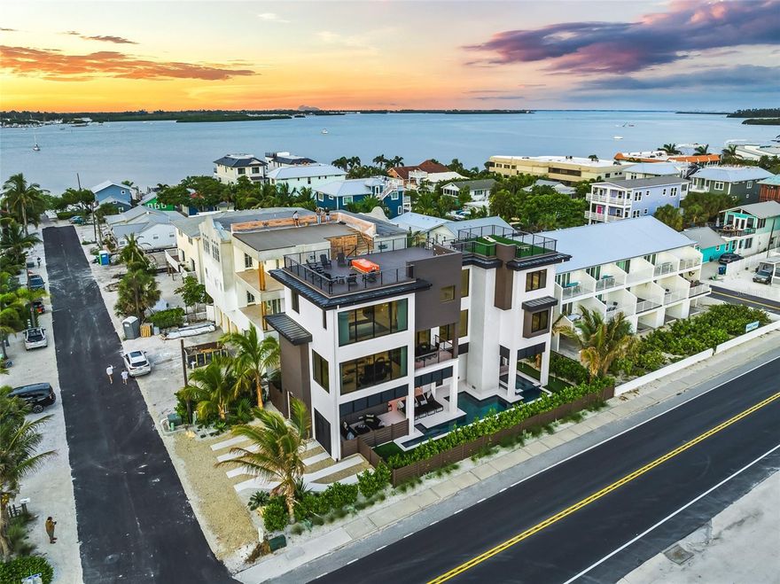 Experience luxury coastal living in this gorgeous modern BEACH HOUSE on Anna Maria Island! Offering full, unobstructed Gulf views this 6-bedroom, 5.5-bath residence features 3,375 sq ft of thoughtfully designed living space and includes an elevator for convenient access to all 3 levels of the home.

The open-concept great room showcases panoramic water views and connects seamlessly to the gourmet kitchen, complete with high-end appliances, premium cabinetry, and a sleek dining area. A spacious balcony extends the living space outdoors, providing the perfect setting for enjoying the incredible water views.

This property comes exquisitely turnkey furnished. The primary suite offers a relaxing retreat with a king-sized bed, spa-style ensuite bathroom, walk-in shower, soaking tub, and double vanities. Guest bedrooms are each generously sized for comfort and relaxation.

Outdoor living is exceptional, highlighted by a rooftop deck with a seating area, and fire pit, ideal for stunning AMI sunsets over the Gulf and complete sunrises over the Bay. The oasis inspired yard features a private heated pool, in-ground spa, outdoor kitchen and a poolside putting green.

Located in beautiful Bradenton Beach, this residence is steps from the shoreline and close to local dining, shopping, and the island’s free trolley. With breathtaking Gulf views from nearly every room and successful vacation rental history, this property is ideal as a full-time residence or investment opportunity. If you are dreaming of a BEACH HOME, this is the one!