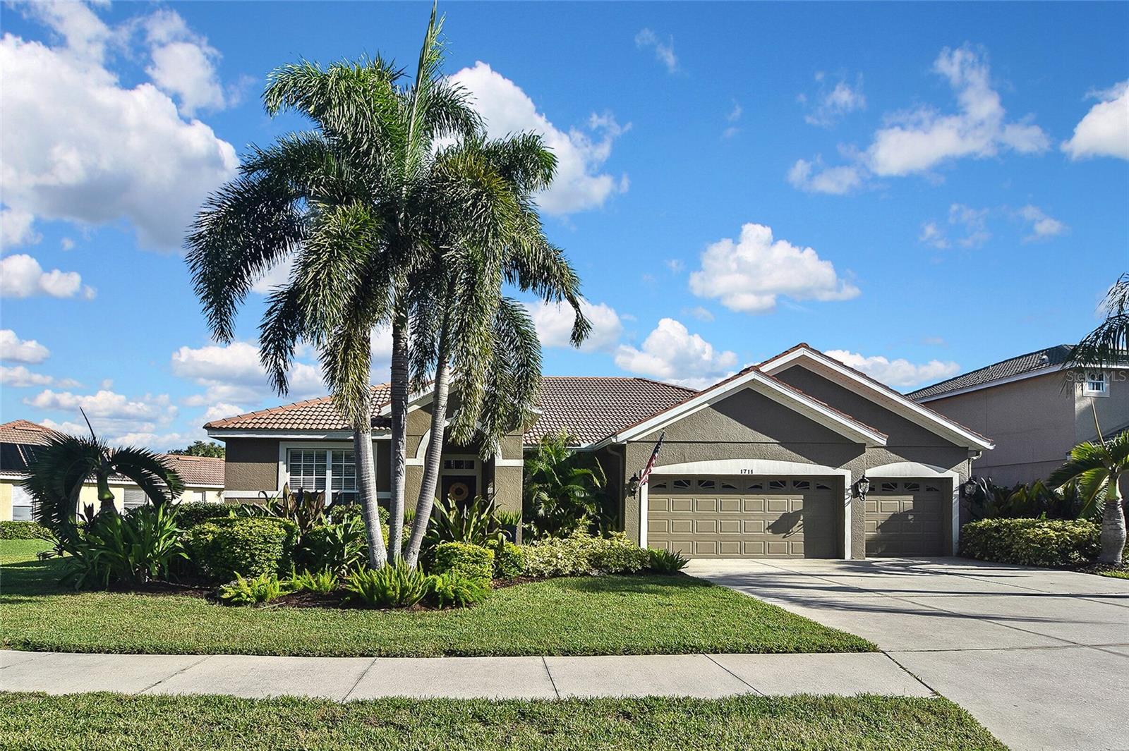 A rare gem has become available in this very desirable community. This spacious 3 bedroom, 2.5 bath home comes with an open floor plan that provides a welcome place for entertaining or a quiet place to relax. Step outside through the pocket sliders to the covered screened in paver lanai, complete with a crystal pool and LP gas heated spa. Enjoy sitting around the LP gas fire pit and gaze upon the gas fed Tiki torches surrounding the back lanai for that tropical oasis feel. The open kitchen shines with 24"x24" tile throughout, the oversized island provides a sit and eat opportunity with the extended quartz counter. The den has amazing hand crafted built in book shelves and desk. The spacious master bedroom comes with a custom walk in closet and beautiful ensuite bathroom with separate sinks and vanities. This is a must see! Newer HVAC, security system, Water heater 2023, irrigation system.