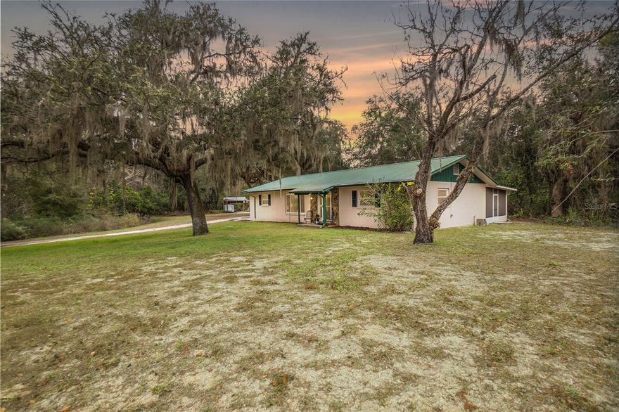 Quiet Country Living on 3 Acres Across from Potts Preserve! Escape to the peaceful country lifestyle you’ve been dreaming of on this picturesque 3-acre Inverness property sprinkled with majestic grandfather oaks. This 3 bedroom, 2 bath home with 1,800 of living space, built in 1978, offers privacy, versatility, and room to live the way you choose. Step inside from the front or side patio, or through the rear lanai that opens directly into the updated kitchen, featuring stainless steel appliances and a warm, inviting flow—perfect for entertaining or everyday living. The owner’s suite includes lanai access and a walk-in closet, plus a unique connection to Bedroom 2, ideal for a home office or nursery. A den/office accessed through the second bathroom offers flexibility and could easily serve as a 4th bedroom. Additional features include a metal roof (2013), updated water heater (2020), water treatment system, 45x14 screen porch w/epoxy floors, leaf filters (2024), and abundant outdoor storage with a pole barn and shed. Car enthusiasts, hobbyists, or outdoor lovers will appreciate the detached garage, perfect for a vehicle, boat, or workshop. The covered pole barn can be easily adapted for horses or farm animals, making this property ideal for a mini-farm or homestead lifestyle. Best of all, the 8,500-acre Potts Preserve is just across the street, offering equestrian trails, hiking, camping, fishing, and endless outdoor adventures right at your doorstep. If you’re looking for space, freedom, and a true connection to nature—this one checks all the boxes. Come experience the lifestyle this special property has to give!
