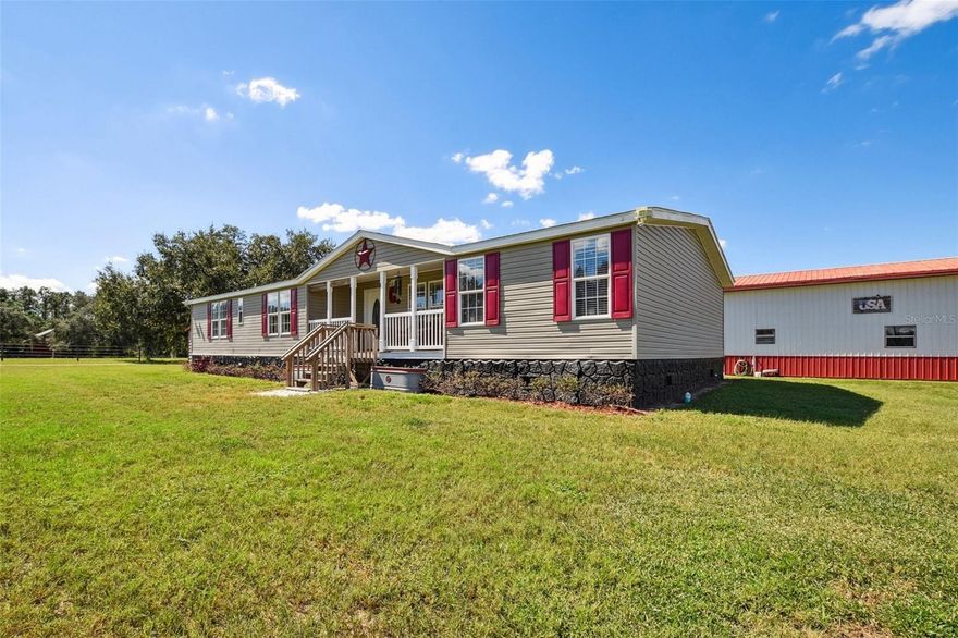 Set among distinguished estates and premier equestrian properties, this 3-bedroom, 2-bath residence offers an exceptional balance of comfort, privacy, and functionality. The approximately 2,000-square-foot home is positioned on 6.38 fully fenced and cross-fenced acres thoughtfully designed for both living and livestock. Equestrian amenities include a three-stall barn with feed and tack room, hay storage, automatic waterers, a dedicated wash area, and high-quality electric fencing with separate pastures. A 54' x 24' detached garage and workshop provides ample space for equipment, vehicles, or hobbies, while covered parking accommodates a horse trailer and RV with both 30- and 50-amp hookups. Enjoy expansive views and a well-planned layout in a setting surrounded by some of the area’s most desirable homes. Conveniently located minutes from the shops and dining of Mount Dora and the waterfront attractions of Tavares, Florida’s Seaplane Capital, the property is also within an hour of Ocala’s World Equestrian Center and offers easy access to Orlando. This is refined Central Florida country living at its best, where space, privacy, and lifestyle come together close to the Harris Chain of Lakes.