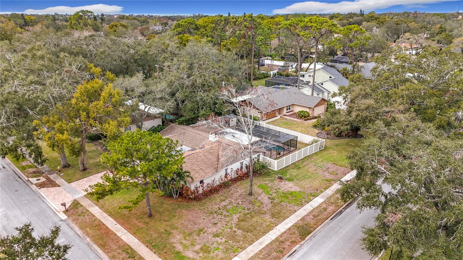 For Rent: This beautifully upgraded 5-bedroom, 3-bathroom pool home is now available for sale or lease at $5,800 per month. Situated on a spacious 0.33-acre corner lot in the highly desirable Eniswood subdivision of unincorporated Pinellas County, this home offers both luxury and versatility. Just a short drive from the Gulf beaches, the famous Sponge Docks, and downtown Palm Harbor, the location provides easy access to some of the area’s best attractions. Inside, the home features a chef’s kitchen designed for culinary enthusiasts, all-new flooring throughout, and a brand-new shed in the backyard for added storage or workspace. A handicap-accessible in-law suite or 5th bedroom with a private bath adds flexibility for multigenerational living or guest accommodations. The living and family rooms are divided by a charming double-sided wood-burning fireplace, while the private master suite includes a walk-in closet, a second closet, and a modern en-suite bathroom with double sinks and a shower/tub combination. A formal dining room and a breakfast nook overlooking the pool offer multiple dining options. The outdoor space is perfect for entertaining, with a spacious pool and patio area ready for your dream setup. Additional features include a new A/C system (2024), newer water softener, irrigation system, hurricane shutters, a pool safety fence, a hurricane-rated garage door, and a vinyl privacy fence. Located within the Palm Harbor University High School zone and close to the Pinellas Trail, beaches, dining, and entertainment, this home truly has it all. Please note: the property is actively listed for both sale and lease.
