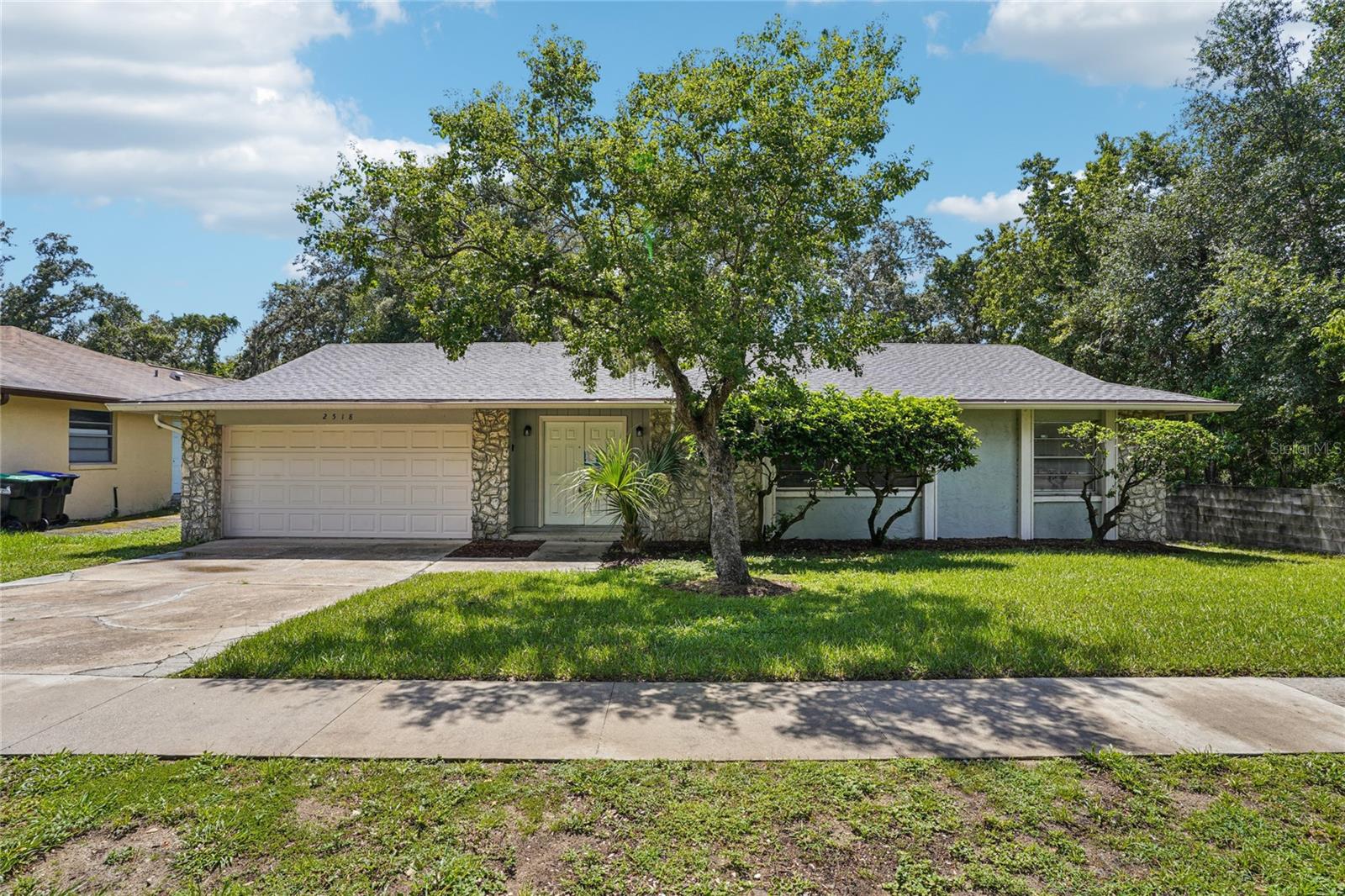 Move-in ready and thoughtfully updated, this 3-bed/2-bath block home offers ~1,680 sq ft of comfortable living in a convenient Orlando location. An open living/dining area with vaulted ceilings and tile flooring sets the tone, flowing to a remodeled kitchen with granite counters, stainless-steel appliances, a breakfast bar, and ample cabinet space. The split-bedroom layout features a private primary suite and two secondary bedrooms with a full bath nearby—easy living for guests, home office, or hobbies. Step outside to a screened patio overlooking a fully fenced backyard with room to play, garden, or grill. Additional highlights include an inside laundry area and a two-car garage for parking and storage. No pool to maintain, just low-stress living close to shopping, dining, parks, and major roadways for simple commutes. If you’re looking for space, updates, and practicality in one package, this one checks the boxes—keys, meet pockets.