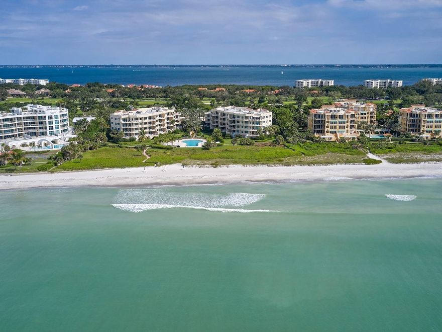 LONGBOAT KEY BEACH FRONT WITH DIRECT GULF VIEWS! This spacious end residence has nearly 2500 square feet of move-in ready interior space that includes three bedrooms, three baths, and a seaside terrace. It is poised along the Gulf of Mexico, overlooking resident exclusive white sandy beaches and azure tides. A semi-private elevator transports you to the lobby accessing only one other unit. A formal foyer moves into a great room plan with approximately 800 square feet of open space with living and dining areas: all overlooking beach views. Triple sliding glass doors crowned with clerestory windows enhances the magnificent views. Open the glass doors fully to entertain seamlessly between the inside and the covered and tiled gulf terrace. At the heart of the home is the sizable eat-in kitchen boasting granite counter tops, a center island, a planning center, and a serving bar.  Sleek white raised panel cupboards have above cabinet display and task lighting beneath. A tray ceiling with recessed lighting creates a light and bright benefit. A stainless-steel refrigerator remains along with a dishwasher, a cooktop, a built-in oven, and microwave.  A pantry provides additional storage space in the eating area. Nearby is a convenient service entrance and a fully equipped laundry room with a sink and cabinetry. The guest wing offers an en suite bed/bath, plus a third bedroom or den with double doors and another bath. A split plan presents a separate primary suite with a large dressing closet that has ceiling to floor, full-length built-ins. Its personal bath showcases marble flooring and matching hand-laid surfaces, including a vanity table and shower surround. The separate jetted tub is swathed in the same marble and has a picture window that looks out over the beach views. This gulf-side wing also accesses the open-air terrace. Bonus features include hurricane shutters on all windows and doors, plus ample parking for extra cars or guests, assigned storage and a 1-car garage. This Longboat Key condominium is part of Villa Di Lancia, a boutique community with only 19 residences in each of its two buildings. Amenities include 24-hour security, 7 days a week with a manned gatehouse, an EV charging station, plus deeded and public beach access, a gulf-side swimming pool and spa, community room with kitchen, fitness center, and tennis courts. It is located immediately adjacent to one of the islands most upscale developments known as Aria. It is close to golf, marinas and a myriad of shopping and dining choices, and conveniently about a half a mile to the Shoppes of Bay Isles. Please note that the furniture is negotiable.