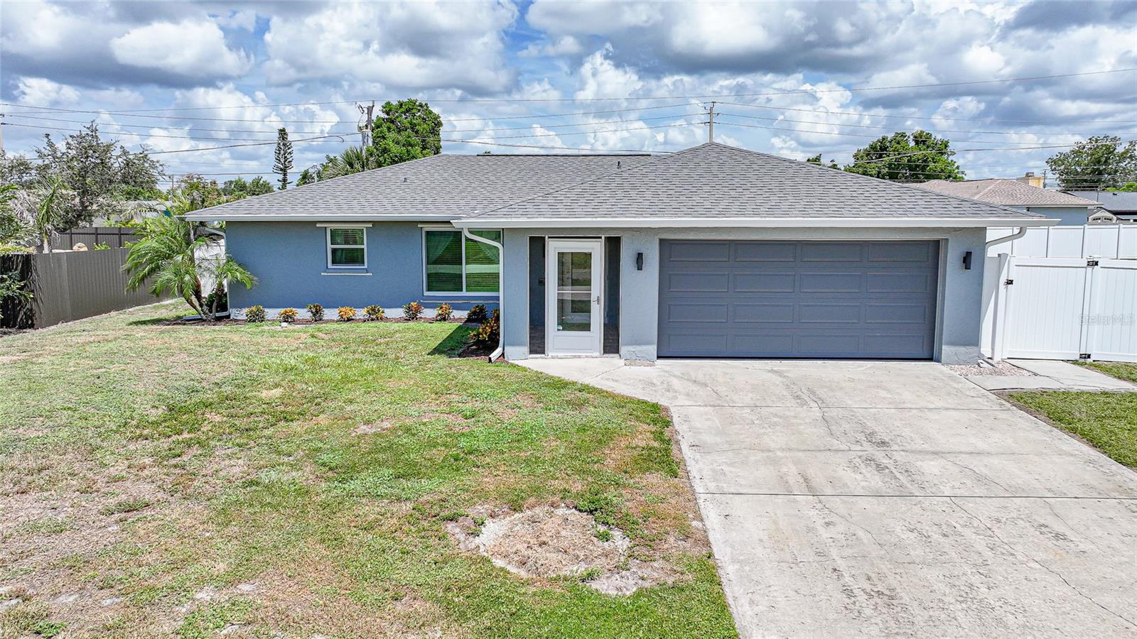 Welcome to this beautifully updated and meticulously maintained pool home situated on just under half an acre of private, fully fenced land. This inviting residence offers the perfect blend of comfort, functionality, and Florida lifestyle living with its spacious 3-bedroom, 2-bathroom split floor plan and stunning outdoor features. As you enter, you’ll immediately notice the open and airy layout filled with natural light. The interior boasts a warm and neutral color palette that complements any style, creating a peaceful and cohesive living environment. The large living area flows seamlessly into the heart of the home – a beautifully updated kitchen outfitted with sleek granite countertops, a generous island with a breakfast bar, and an abundance of cabinetry for storage. Stainless steel appliances bring a modern touch and reliable performance for everyday cooking and entertaining. The master suite is a tranquil retreat, complete with elegant double barn doors that lead to a spacious en-suite bathroom. This luxurious space includes a split double vanity, a large walk-in shower, and thoughtful design touches that make it feel like a spa. On the opposite end of the home, guests will enjoy their own private space with a well-sized bedroom and accompanying full bathroom. The den/3rd bedroom provides additional flexibility and can be used as a home office, hobby room, or bedroom. Step outside to a true backyard oasis, where you’ll find a sprawling paver pool deck surrounding a massive in-ground pool. Whether you're hosting summer cookouts or enjoying a quiet evening with family, the outdoor kitchen is fully equipped to handle it all. The fenced backyard ensures total privacy while offering plenty of room for play, gardening, or storing your recreational toys, thanks to the generous lot size. Additional upgrades throughout the home include a new air conditioning system, new roof, and new water heater. The garage has been finished with an epoxy-coated floor and even features air conditioning, making it ideal for a home gym, workshop, or climate-controlled storage. Two sheds offer additional storage, and the included hot tub and fire pit create the perfect setting for relaxing evenings under the stars. This home has been thoughtfully updated and lovingly cared for, offering a rare combination of indoor comfort and outdoor paradise. Located in a peaceful setting yet still close to everything, it’s the kind of property that doesn’t come along often. Don’t miss your opportunity to own this slice of Florida paradise. Schedule your private showing today—this home won’t stay on the market for long!