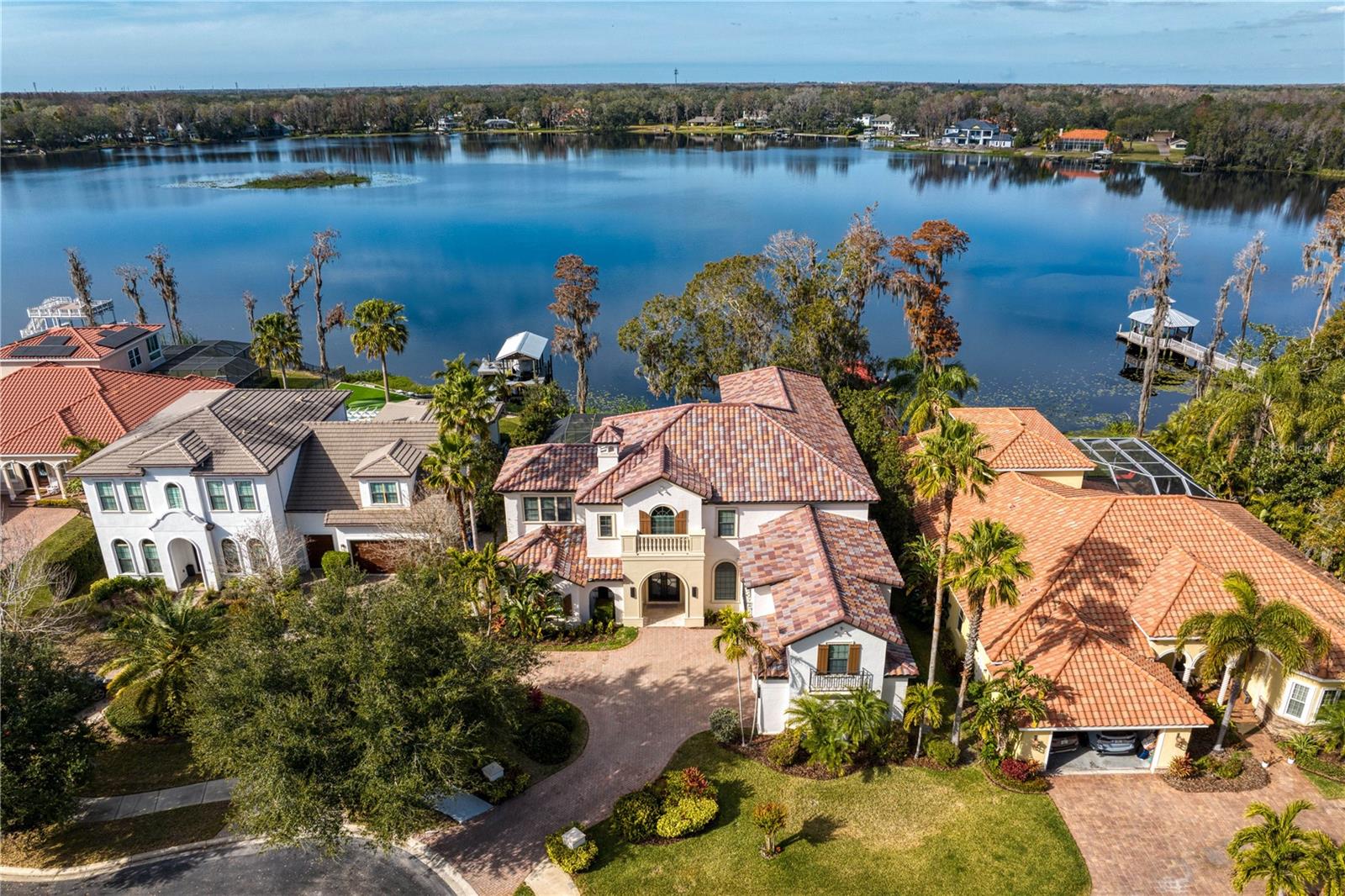One or more photo(s) has been virtually staged. Lakeside. Location. Lifestyle - Call to experience all 3! Step inside a home where every detail feels fresh, inviting, and designed for the way you want to live. Perfectly positioned in the exclusive gated community of Haven Bend on ski-sized Lake Platt, this Bayfair custom built estate offers 6,184 SF of beautifully refreshed living, including a newly painted interior, updated kitchen cabinetry, and stylish new lighting accents. Located in a natural gas community and offering peace of mind with a brand-new barrel tile roof installed in 2024, this residence blends timeless comfort with thoughtful updates. Here, mornings begin with coffee by the water and evenings end with sunsets from your private dock– the lifestyle you’ve been waiting for.
• EXCLUSIVE COMMUNITY: With only 34 homes in this gated enclave, you’ll enjoy both privacy and connection in a rare lakefront setting.
• SPACIOUS DESIGN: Offering 5 bedrooms and 4.5 bathrooms, including a desirable first-floor primary suite with private pool access, a private in-law suite with its own staircase, and a large upstairs bonus room with a screened-in balcony- perfect for guests, teens, or a home office. A versatile study on the second floor can also serve as a 6th bedroom if needed.
• PRIME LOCATION: Adjacent to Carrollwood Day School, a nationally recognized private school offering the prestigious International Baccalaureate (IB) curriculum from Pre-K through 12th grade. A dedicated gate allows residents to easily walk to the school- a rare advantage in Tampa Bay. Learn more at www.carrollwooddayschool.org.
• WATERFRONT LIFESTYLE: Located directly on ski-sized Lake Platt, this home offers a true waterfront lifestyle- enjoy wakeboarding, paddle-boarding, canoeing, tubing, water skiing, and fishing right from your backyard. Cap off your day with breathtaking sunset views or a relaxing cruise from your private dock.
• PEACE OF MIND UPDATES: Barrel tile roof installed November 2024; three AC units replaced (Feb 2024, May 2024, Oct 2018); new KitchenAid dishwasher November 2024; garbage disposals replaced Dec 2024 and Nov 2023; outdoor built-in BBQ grill Oct 2024; wood floors installed in the primary suite and closet July 2024; pool heater and variable-speed pump replaced in 2022; new salt system added July 2022; freshly painted interior in 2025; and kitchen cabinetry refinished with updated pendant lighting and select new lighting accents throughout.
• GATHERING SPACES: A striking iron and glass entry door opens to a 2-story foyer leading into the living room with a dramatic 22 foot stacked stone gas fireplace, perfectly positioned beside the dining room for effortless entertaining. The kitchen, complete with a gas range, double ovens, spacious island, and built-in desk, flows seamlessly into the family room with a brand-new 85 inch TV- creating the perfect setting for both daily living and special gatherings.
• OUTDOOR OASIS: Heated, screened-in pool, outdoor kitchen, and private dock create the perfect backdrop for both relaxation and entertaining.
• A rare blend of privacy, comfort, and convenience- conveniently located near top schools, dining, shopping, major highways, and all that Tampa Bay has to offer. This Haven Bend retreat is designed for everyday living and memorable gatherings, putting everything you need right at your doorstep.