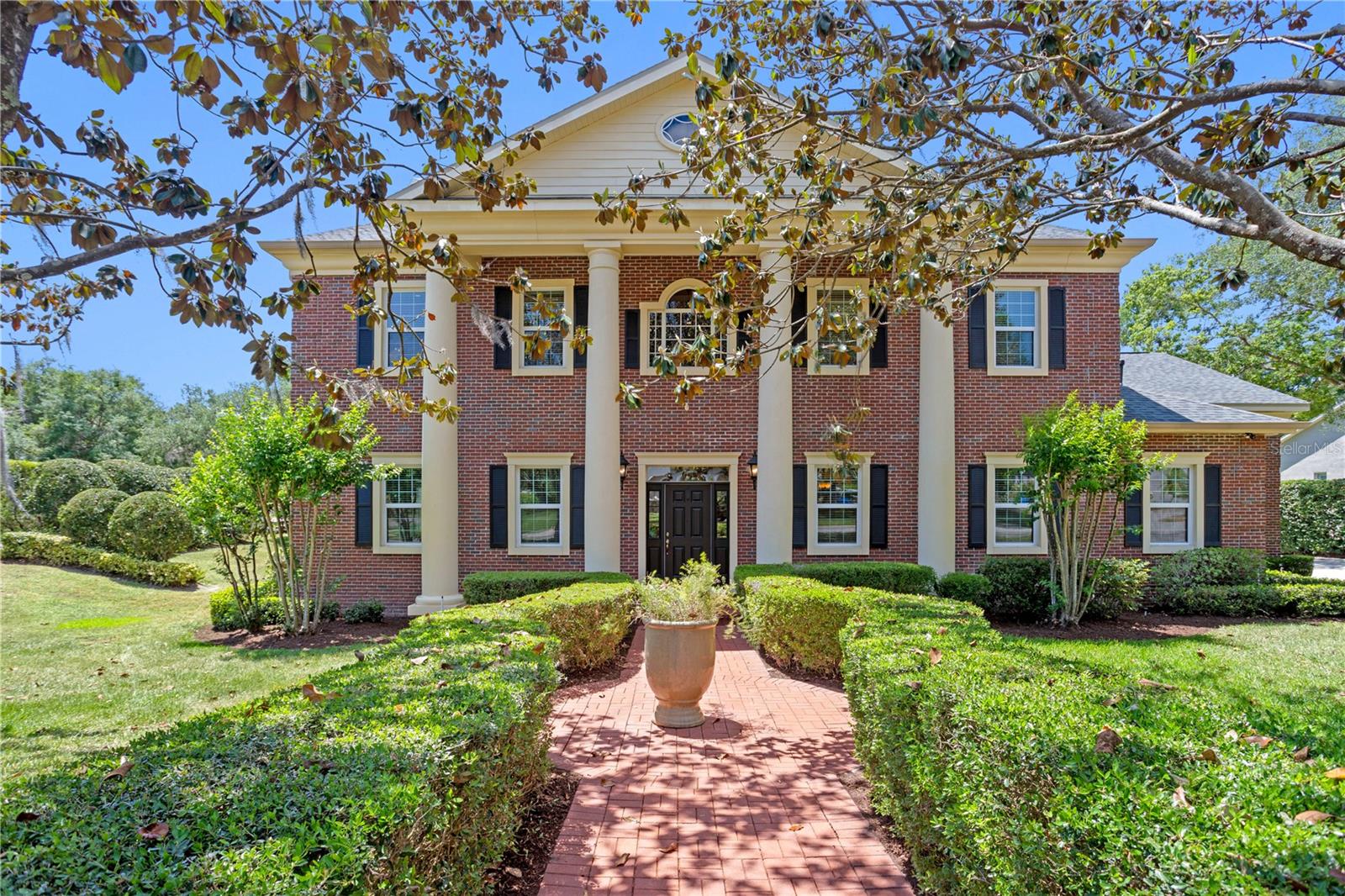 Tucked away in the sought-after back section of the FishHawk Trails Reserve community, this exceptional residence sits on a generous corner lot, offering both privacy and peaceful natural surroundings. Bathed in natural light, the home enjoys scenic views of a tranquil wooded conservation area from the expansive backyard, pool, and outdoor living spaces. Inside, rich natural tones and thoughtful designer finishes create a warm, cohesive ambiance throughout. Recent upgrades include a NEW ROOF (2019), NEW A/C WITH BLUE LIGHT (2020), BOTH WATER HEATERS REPLACED (2023), and a NEW POOL FILTER, PUMP & SALT CELL (2021). The primary suite also features its own dedicated water heater for enhanced comfort. The main level welcomes you with warm redwood hardwood flooring and elegant French-pattern tumbled travertine in the entryway, kitchen, and bathrooms. At the heart of the home is a chef’s kitchen that feels straight out of a design magazine. Soft creamy custom 42” all-wood cabinetry is beautifully contrasted by a rich espresso island—both brought together by rare Antique Wood quartzite countertops that run seamlessly across the space, including the island, wet bar, bathrooms, and laundry room. This natural stone, with its unique veining and warm, earthy tones, ties the entire home together with a sense of organic elegance. Gourmet touches abound with GE Café appliances, a premium refrigerator and dishwasher, and a show-stopping industrial-grade Viking range with six burners, integrated grill, dual ovens, warming shelf, and commercial-style hood. The oversized island features bar seating and a vegetable prep sink—ideal for both everyday use and entertaining. The kitchen flows effortlessly into the spacious family room and out through French doors to a covered lanai, creating a perfect indoor-outdoor living experience. A stylish wet bar, shared between the family room and main living room, further enhances the entertaining potential. The main floor also includes a beautifully updated pool bath with marble-tiled shower, a private office, and a separate in-law suite with its own entrance—ideal for guests, extended family, or a secluded home office. Upstairs, the natural warmth continues with refinished hardwood floors throughout. The reimagined primary suite is a serene sanctuary, offering a spa-inspired bath with a freestanding soaking tub, expansive marble walk-in shower, and French doors that open to a full-length upper balcony. Both Jack-and-Jill bedrooms also feature direct access to the balcony, offering sweeping views of the backyard and conservation area. A large upstairs en-suite bedroom with walk-in closet and full bath, plus a versatile bonus room, round out the second level. Step outside to your private outdoor oasis. The double-level screened lanai is a showstopper—featuring a glistening pool, elevated spa, and expansive covered patio for dining, lounging, or hosting. Surrounded by lush greenery and serene wooded views, this backyard offers the ultimate in Florida living—peaceful, private, and perfectly designed for relaxation. Copy and paste this link to tour the home virtually: my.matterport.com/show/?m=FQUhizVcHGq