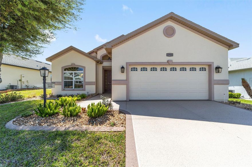 Welcome to this impeccably maintained Hickory model residence located in North Valley / Northern Oaks. Built in 2020, the home is in excellent condition, showing minimal signs of use. Offered as turnkey (partially furnished with limited exceptions) with kitchen items, some decor and linens; the property features a light-filled, pristine foyer upon entry. The dining room, situated to the left, is elegantly furnished and decorated. The spacious kitchen is equipped with gorgeous granite countertops, an island, stainless steel appliances, cabinetry with pull-out shelves, and a double-door pantry, providing an ideal environment for gatherings and entertainment.  You will also find three (3) bedrooms, two (2) full bathrooms, a generously sized great room and a lovely sunroom - all beautifully decorated.  Additional features include five-inch baseboards throughout, some crown moldings, ceiling fans, and a primary bathroom custom-built with a Roman shower - featuring no step or lip and grab bars for convenience. A connecting door links the primary bedroom to the third bedroom, while the front (second) bedroom currently serves as an office. The sizeable laundry room is conveniently located adjacent to the kitchen and features storage cabinets and a laundry sink. The lanai was built as a sunroom with glass windows, blinds, climate control, and leads to an outdoor patio suitable for morning coffee or evening refreshments.  All concrete surfaces, including the driveway, sidewalk, and front porch, are finished with designer paint & texture, while the garage, sunroom, and back patio feature epoxy coatings. The HVAC system receives regular service every six months, and the home holds a termite bond. The stove and refrigerator are just two years new. This pet-free, smoke-free, and deep fry-free property is move-in ready. A golf cart with lithium battery is available for purchase separately.  Stonecrest is a 55+ gated community located just east of The Villages, accessible by golf cart. Amenities include four heated saltwater pools (one indoor Olympic-sized), a clubhouse, fitness center, tennis and pickleball courts, dog park, numerous social clubs, community events, and an on-site restaurant. The community does not have any CDD or Bonds. The Villages offers nightly entertainment, dining, live music, and various shopping options such as Aldi, Walmart, Lowe’s, and BJ’s—all reachable by golf cart. We invite you to schedule a viewing of this outstanding home.