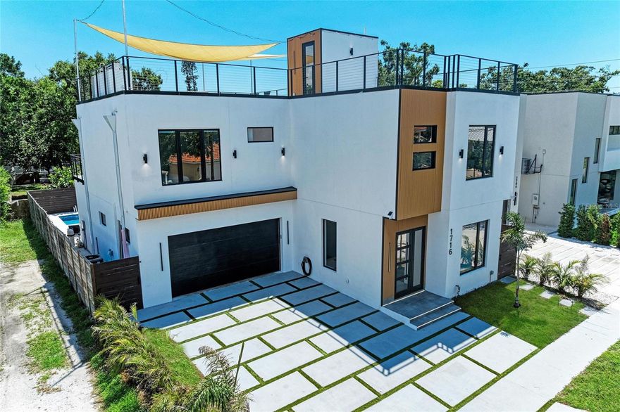 Welcome to this beautifully crafted 4-bedroom, 5-bathroom pool home with a 2-car garage, located in one of the best areas of Sarasota. Built in 2025, this residence showcases modern elegance blended seamlessly with the laid-back charm of Florida living. From the moment you arrive, you'll appreciate the home's refined curb appeal, highlighted by its neutral palette, expansive floor tiles throughout, recessed LED lighting, and high-end Level 5 smooth wall finishes.

Step inside to a thoughtfully designed open-concept layout that connects the living, dining, and kitchen areas, creating an ideal setting for entertaining or everyday living. The chef-inspired kitchen features a double oven, a spacious island with seating, a built-in wine fridge, and ample storage. Large sliding glass doors in the dining area open directly to the backyard, creating an effortless indoor and outdoor lifestyle. An outdoor kitchen makes al fresco dining easy, while the private pool transforms the space into a resort-style retreat.

The primary suite is a true sanctuary, complete with a walk-in closet and a luxurious en-suite bathroom featuring dual vanities, generous cabinet storage, modern lighting, and a sleek walk-in shower. Two additional bedrooms are ideal for guests or family, each offering upgraded closet systems. A second full bathroom provides a double vanity and a tub and shower combination, echoing the home’s upscale design. Working from home or needing a private space, the dedicated office area offers the flexibility to be transformed into a den, creative studio, or study. The laundry room is fully equipped with washer and dryer units for added convenience, and the oversized 2-car garage features an epoxy-coated floor for both functionality and visual appeal.

Outdoor living is elevated with a large covered patio space perfect for lounging or dining al fresco. The beautifully paved area overlooks a peaceful backyard and a refreshing pool with a waterfall feature, offering your own private oasis. Multiple access points throughout the home lead to terrace-style balconies, ideal for soaking in the Florida sunshine and views. As a bonus, the rooftop den provides an exclusive space to relax or entertain, complete with impressive cityscape views, the perfect spot for sunset cocktails or quiet mornings.

Beyond its stunning design, this property also presents a vacation rental investment opportunity for investors looking to move their money via a 1031 exchange, with gross annual revenue of up to $221,000! Additionally, with its DTN zoning, the home offers the unique ability to operate low-intensity professional businesses such as medical, wellness, or design services while welcoming clients directly to a dedicated front section of the residence.

Just steps from Main Street, a neighborhood park, and a boat ramp, this home offers unmatched convenience. The marina and Sarasota’s lively downtown are only minutes away, giving you easy access to the city’s best dining, shopping, and entertainment. Half a block from Gillespie Park with its tennis courts and green space and close to the new 50-acre Bay Sarasota Park, you’ll enjoy expansive lawns, cultural venues, and recreational areas for outdoor enjoyment.

Schedule a showing today and experience this exceptional Sarasota home for yourself.