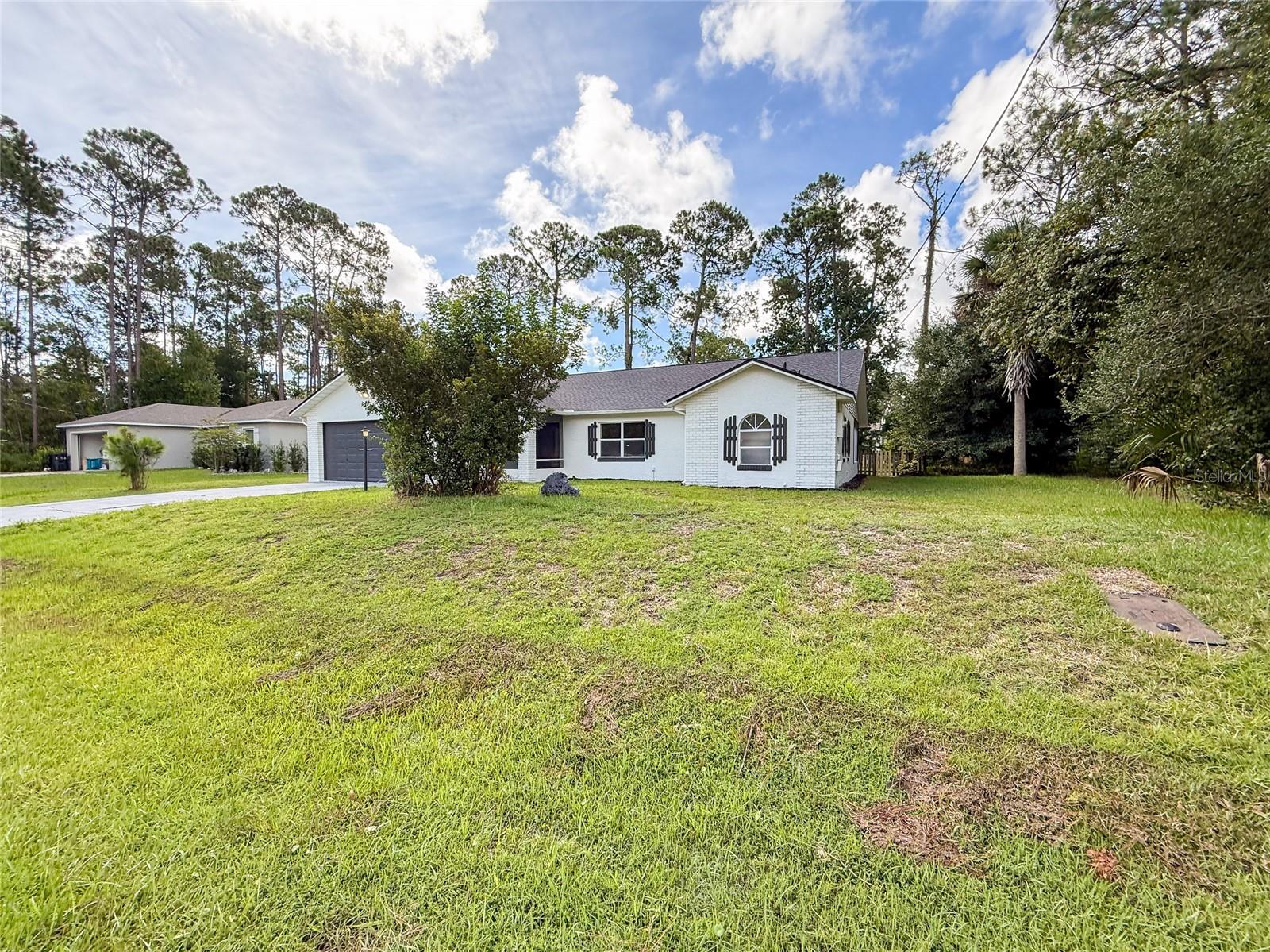 This completely updated CONCRETE BLOCK, BRICK FRONT home offers comfort, style, and efficiency in one perfect package. Enjoy peace of mind with a NEW ROOF, NEWER HVAC (2024), and a SOLAR OPERATED WATER HEATER that conserves energy. Freshly painted inside and out, this home shines with ALL NEW FIXTURES, NEW SOFT CLOSE WHITE SHAKER CABINETS, ALL SS APPLIANCES, and gleaming QUARTZ COUNTER TOPS. NEW LVP FLOORING flows through the main living areas, while NEW CARPETS add comfort to the bedrooms. The LARGE MASTER BEDROOM provides a private retreat, and the EXPANSIVE 416 SQ FT SUNROOM offers endless possibilities for relaxation or entertaining. The fully fenced backyard includes a STORAGE SHED COMPLETE W/ WORK BENCH AND ELECTRICITY — perfect for projects or extra storage. Situated on a PRIVATE LOT, currently, with a wooded lot next door, you'll enjoy having ONLY ONE NEIGHBOR! This home truly has it all — modern upgrades, energy savings, and a serene setting.